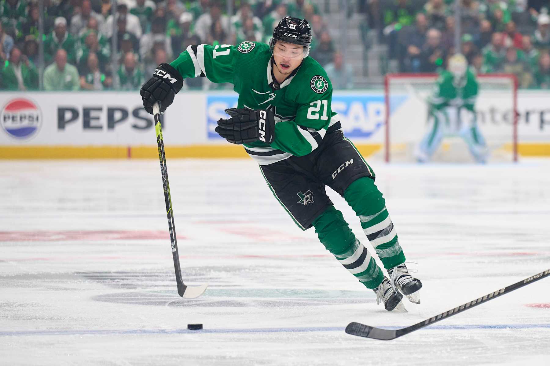 DALLAS, TEXAS - MAY 05: Jason Robertson #21 of the Dallas Stars controls the puck against the Vegas Golden Knights in Game Seven of the First Round of the 2024 Stanley Cup Playoffs at the American Airlines Center on May 5, 2024 in Dallas, Texas.  (Photo by Cooper Neill/Getty Images)
