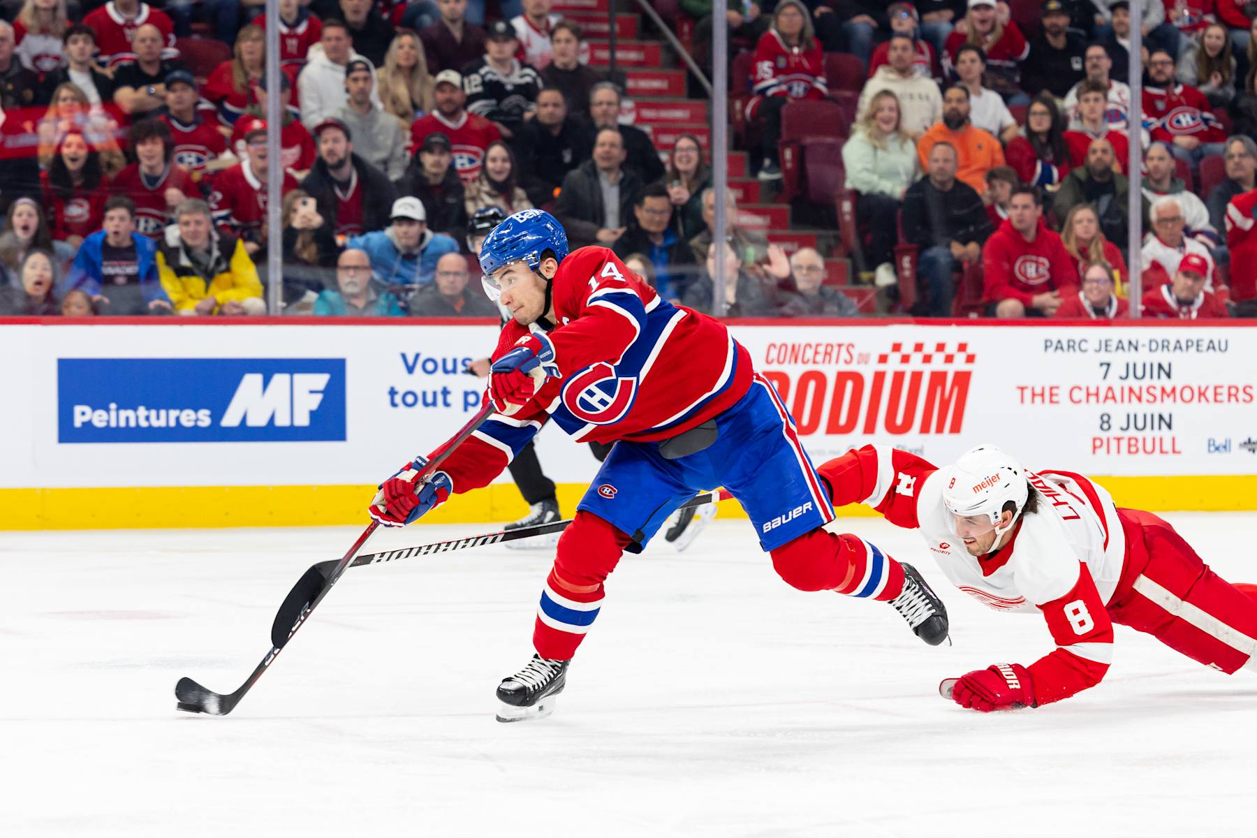 MONTREAL, CANADA - APRIL 16: Nick Suzuki #14 of the Montreal Canadiens  takes a shot on goal during the third period the NHL regular season game between the Montreal Canadiens and the Detroit Red Wings at the Bell Centre on April 16, 2024 in Montreal, Quebec, Canada. (Photo by Vitor Munhoz/NHLI via Getty Images)