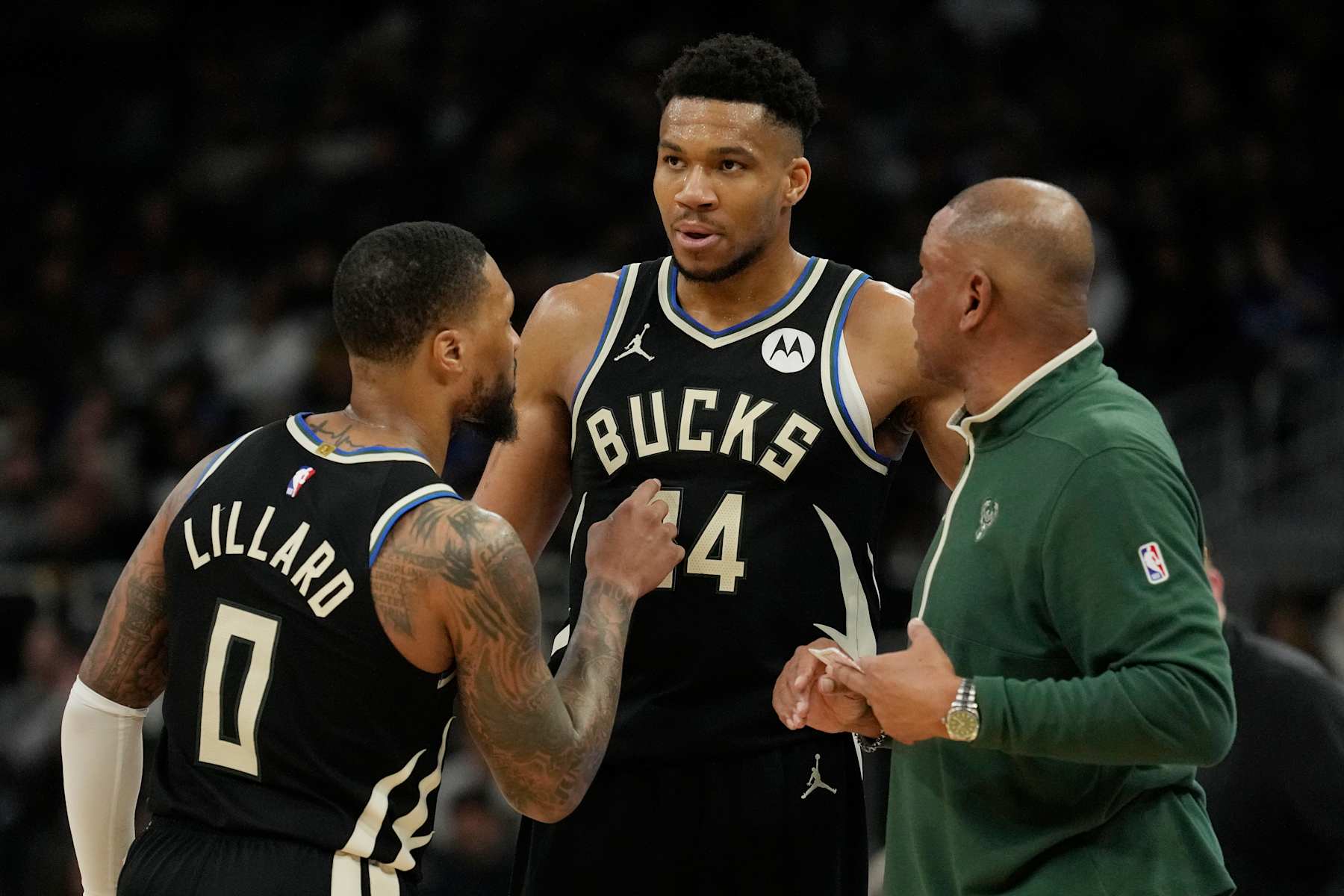 MILWAUKEE, WISCONSIN - APRIL 07: Damian Lillard #0, Giannis Antetokounmpo #34 and ead coach Doc Rivers of the Milwaukee Bucks talk during the first half of the game against the New York Knicks at Fiserv Forum on April 07, 2024 in Milwaukee, Wisconsin. NOTE TO USER: User expressly acknowledges and agrees that, by downloading and or using this photograph, User is consenting to the terms and conditions of the Getty Images License Agreement. (Photo by Patrick McDermott/Getty Images)