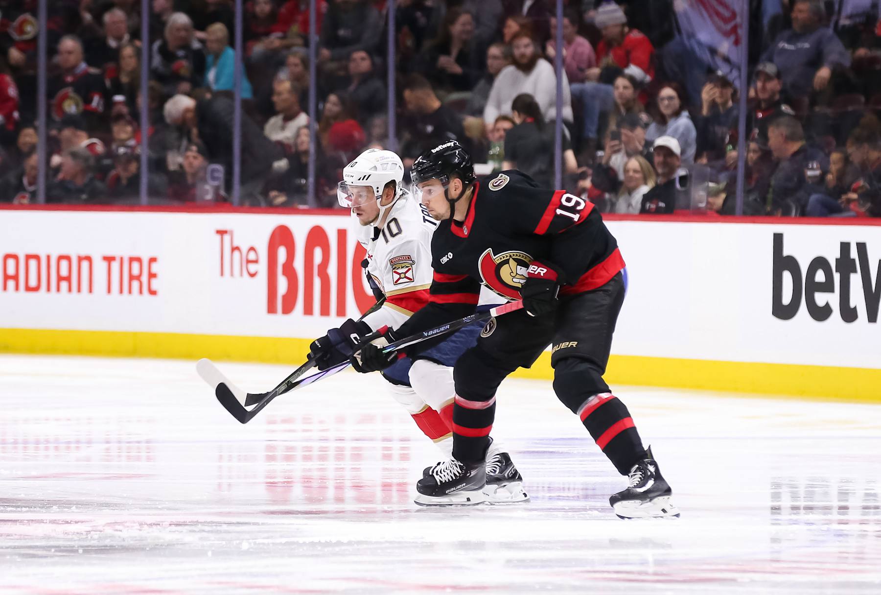 OTTAWA, CANADA - APRIL 04: Vladimir Tarasenko #10 of the Florida Panthers battles Drake Batherson #19 of the Ottawa Senators for position during the opening faceoff at Canadian Tire Centre on April 04, 2024 in Ottawa, Ontario, Canada. (Photo by Chris Tanouye/Freestyle Photography/Getty Images)