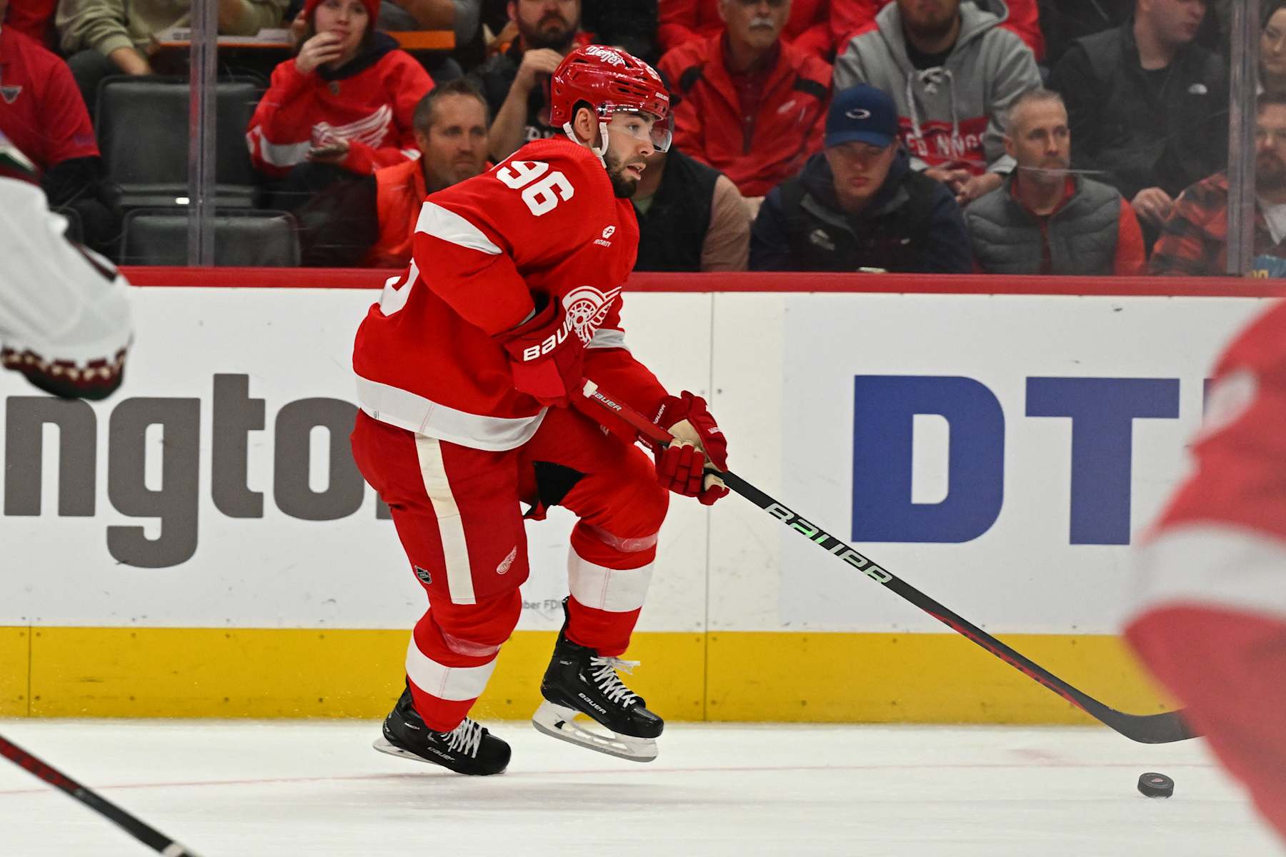 DETROIT, MI - MARCH 14: Detroit Red Wings defenseman Jake Walman (96) moves with the puck along the boards during the game between the Detroit Red Wings and the Arizona Coyotes Thursday March 14, 2024 at Little Caesars Arena in Detroit, MI. (Photo by Steven King/Icon Sportswire via Getty Images)