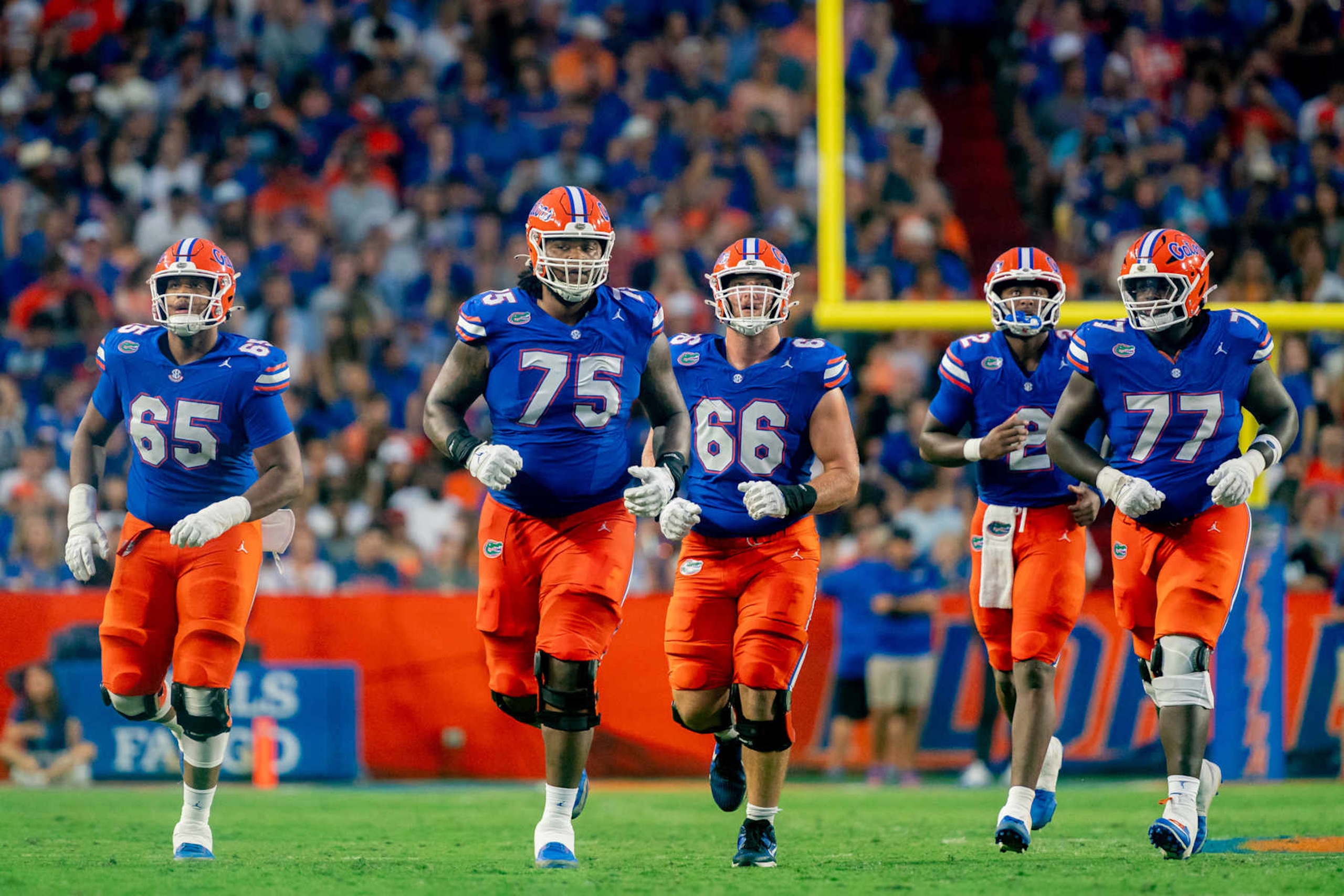 GAINESVILLE, FL - SEPTEMBER 07: Florida Gators offensive lineman Kamryn Waites (75), Florida Gators offensive lineman Jake Slaughter (66),Florida Gators offensive lineman Brandon Crenshaw-Dickson (65),Florida Gators offensive lineman Knijeah Harris (77) and Florida Gators quarterback DJ Lagway (2) jog down the field during a college football game between the Samford Bulldogs and the Florida Gators on September 7th, 2024 at Ben Hill Griffin Stadium in Gainesville, FL. (Photo by Chris Leduc/Icon Sportswire via Getty Images)