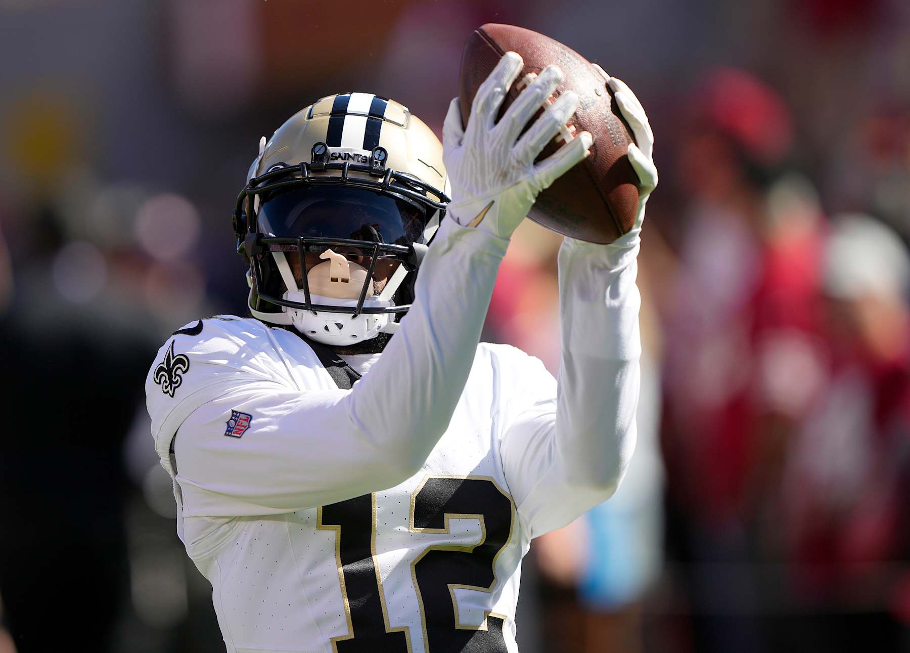 SANTA CLARA, CALIFORNIA - AUGUST 18: Chris Olave #12 of the New Orleans Saints warms up prior to the start of a preseason game against the San Francisco 49ers at Levi's Stadium on August 18, 2024 in Santa Clara, California. (Photo by Thearon W. Henderson/Getty Images)