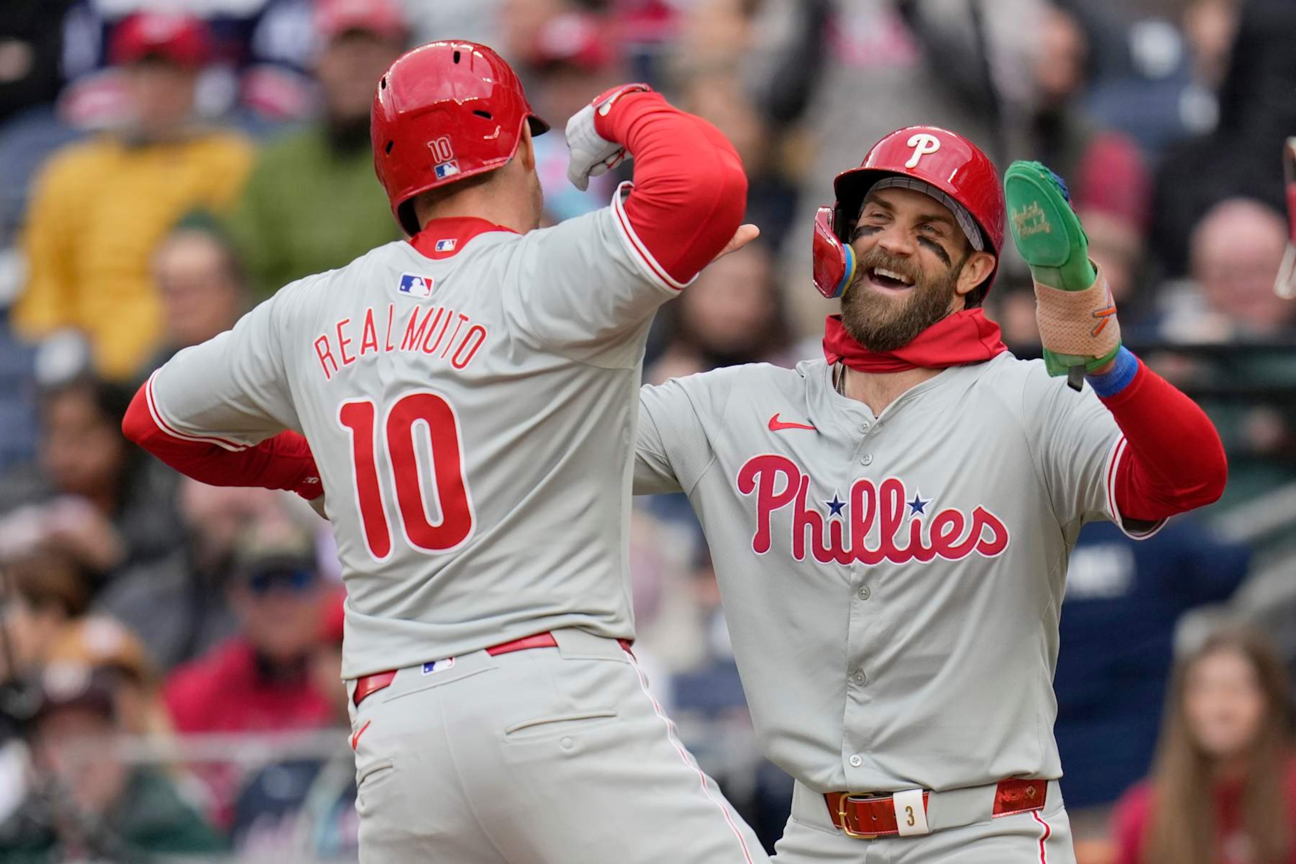 WASHINGTON, DC - APRIL 06: J.T. Realmuto #10 of the Philadelphia Phillies celebrates with Bryce Harper #3 after hitting a three run home run against the Washington Nationals during the third inning at Nationals Park on April 06, 2024 in Washington, DC. (Photo by Jess Rapfogel/Getty Images)