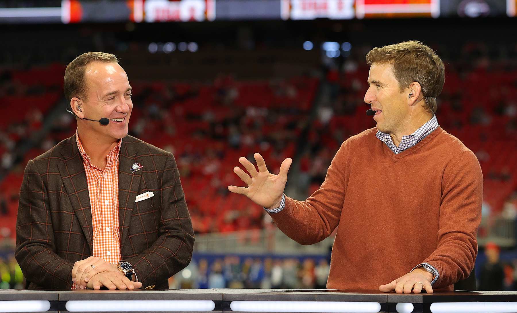 ATLANTA, GEORGIA - DECEMBER 03:  (L-R) Former Football Quarterbacks Peyton Manning and Eli Manning talk prior to the SEC Championship game between the LSU Tigers and the Georgia Bulldogs at Mercedes-Benz Stadium on December 03, 2022 in Atlanta, Georgia. (Photo by Kevin C. Cox/Getty Images)