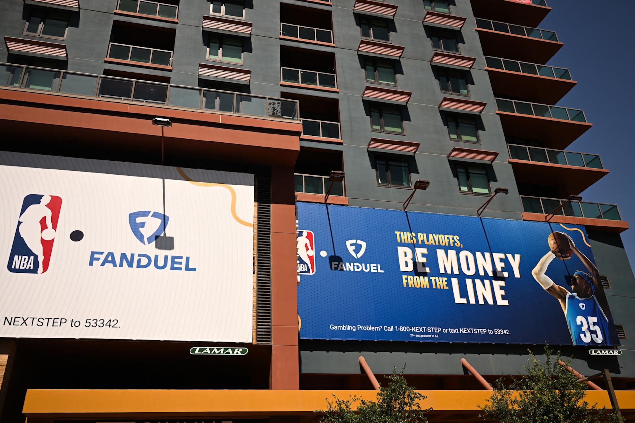 NBA and FanDuel online sports betting signage is displayed on the side of a building in Phoenix, Arizona, on June 5, 2024. (Photo by Patrick T. Fallon / AFP) (Photo by PATRICK T. FALLON/AFP via Getty Images)