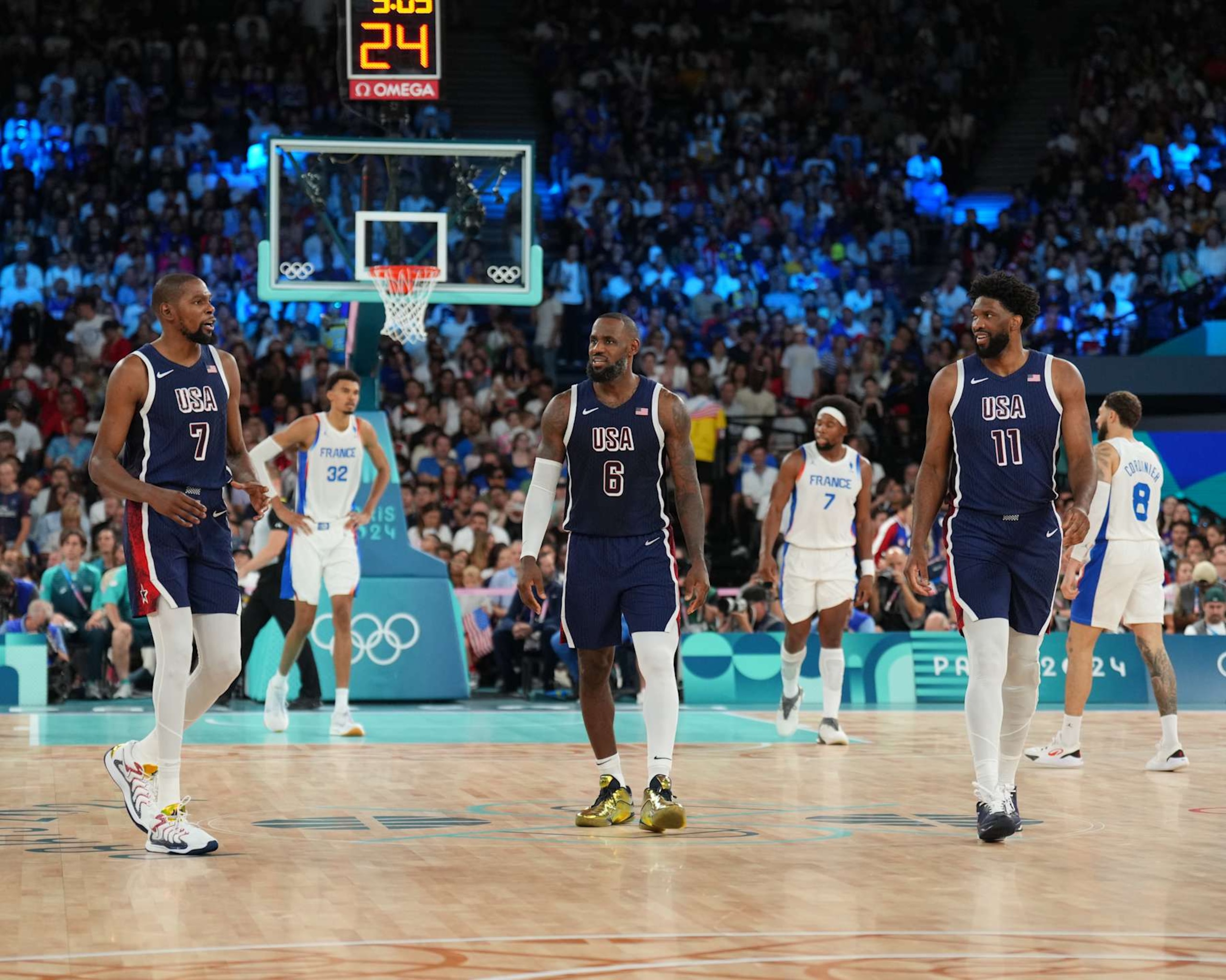 PARIS, FRANCE - AUGUST 10: Kevin Durant #7, LeBron James #6, and Joel Embiid #11 of Team USA talk during the game against Team France during the Men's Gold Medal Game on August 10, 2024 at the AccorHotels Arena in Paris, France. NOTE TO USER: User expressly acknowledges and agrees that, by downloading and/or using this photograph, user is consenting to the terms and conditions of the Getty Images License Agreement. Mandatory Copyright Notice: Copyright 2024 NBAE (Photo by Jesse D. Garrabrant/NBAE via Getty Images)