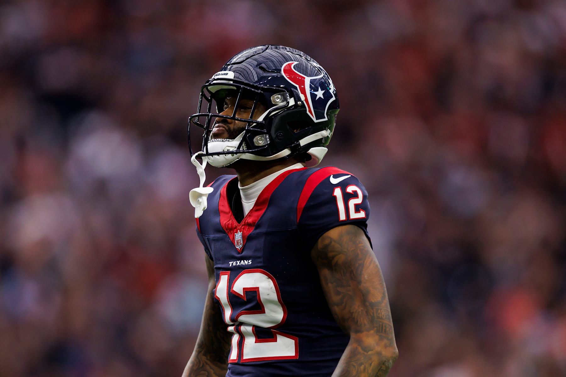 HOUSTON, TEXAS - JANUARY 13: Nico Collins #12 of the Houston Texans celebrates after a catch during an AFC wild-card playoff football game against the Cleveland Browns at NRG Stadium on January 13, 2024 in Houston, Texas. (Photo by Ryan Kang/Getty Images)