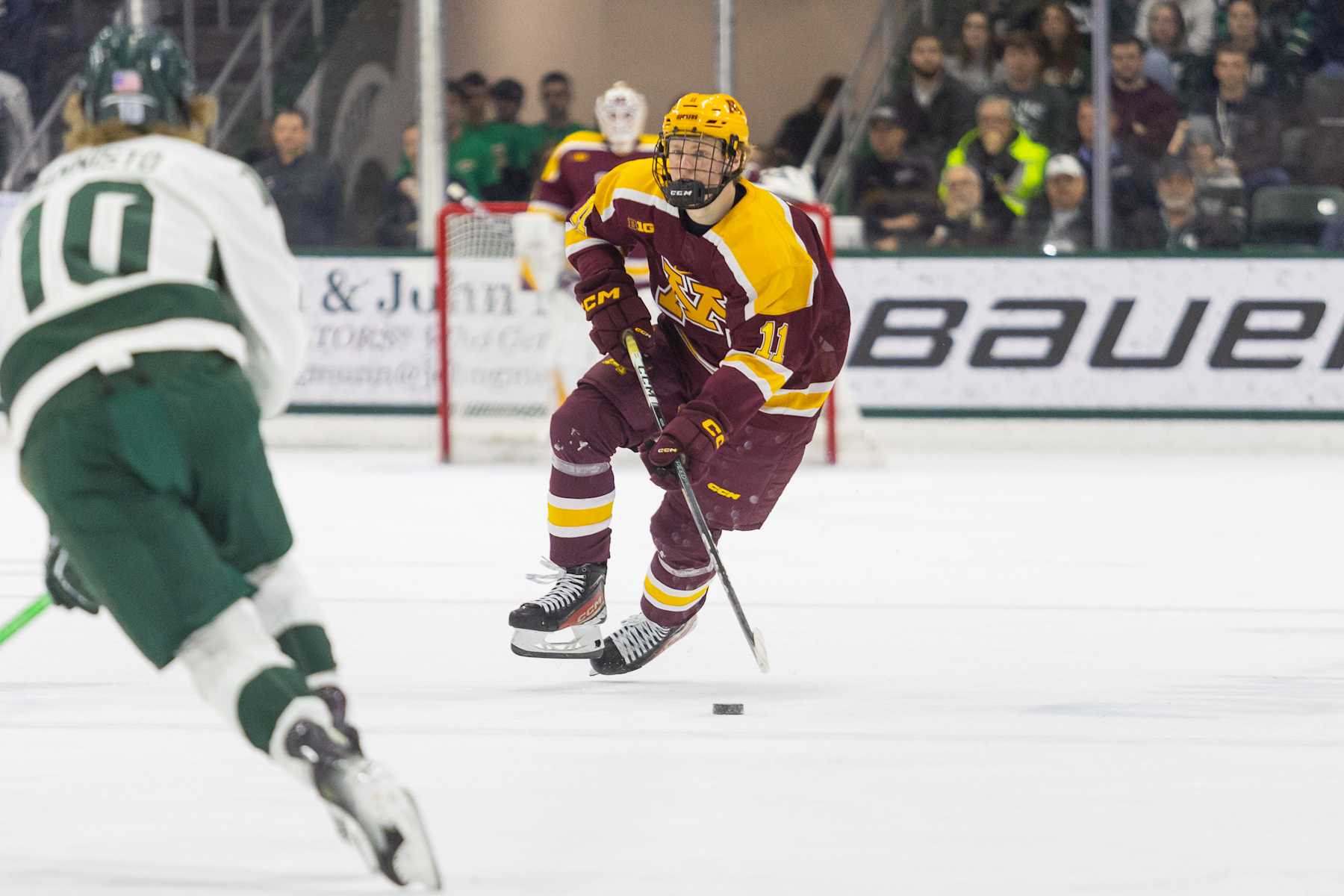 EAST LANSING, MI - JANUARY 26: Oliver Moore #11 of Minnesota skates with the puck during a game between University of Minnesota and Michigan State University at Munn Ice Arena on January 26, 2024 in East Lansing, Michigan. (Photo by Michael Miller/ISI Photos/Getty Images)