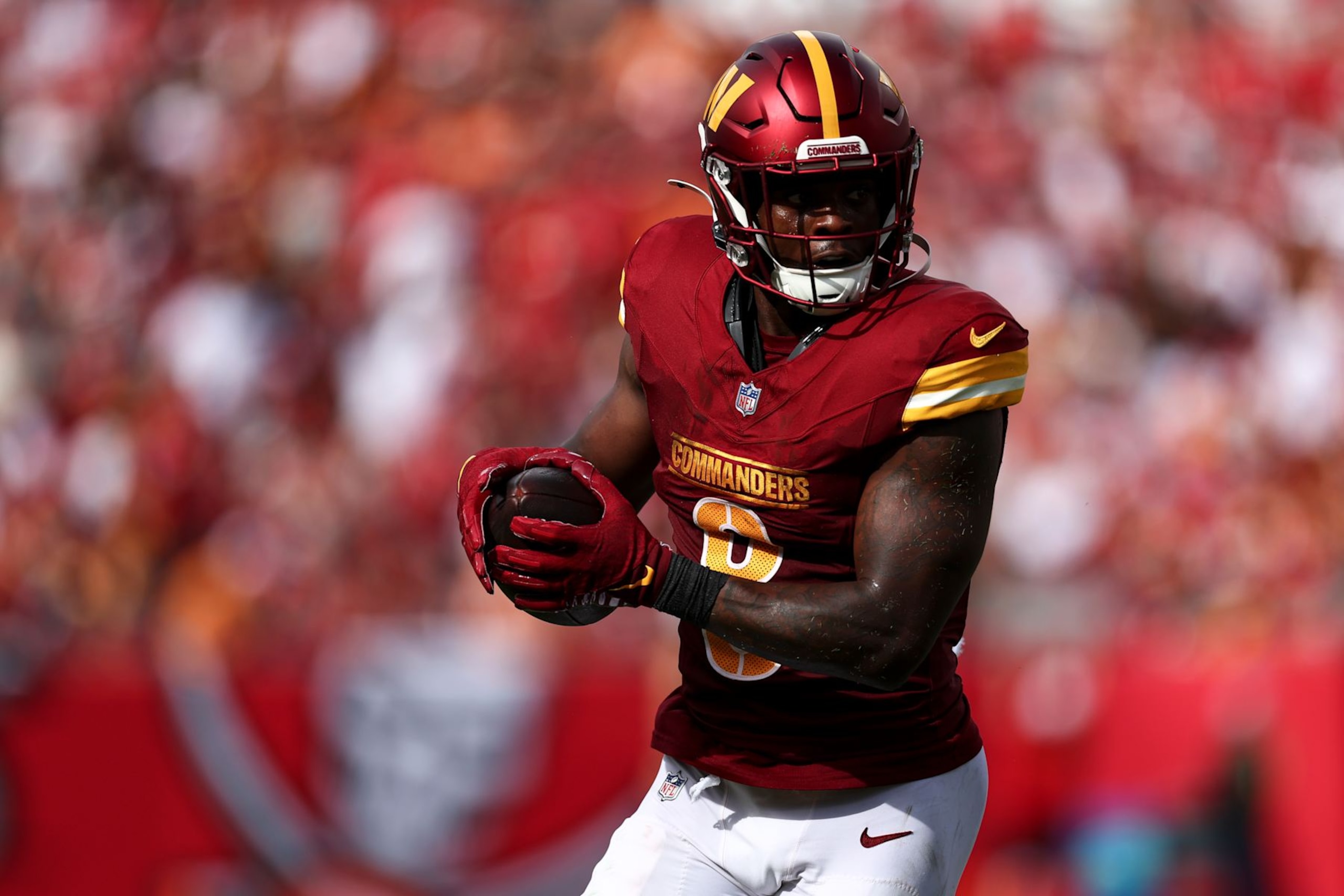 TAMPA, FL - SEPTEMBER 8: Brian Robinson Jr. #8 of the Washington Commanders carries the ball during the first quarter of an NFL football game against the Tampa Bay Buccaneers at Raymond James Stadium on September 8, 2024 in Tampa, Florida. (Photo by Kevin Sabitus/Getty Images)
