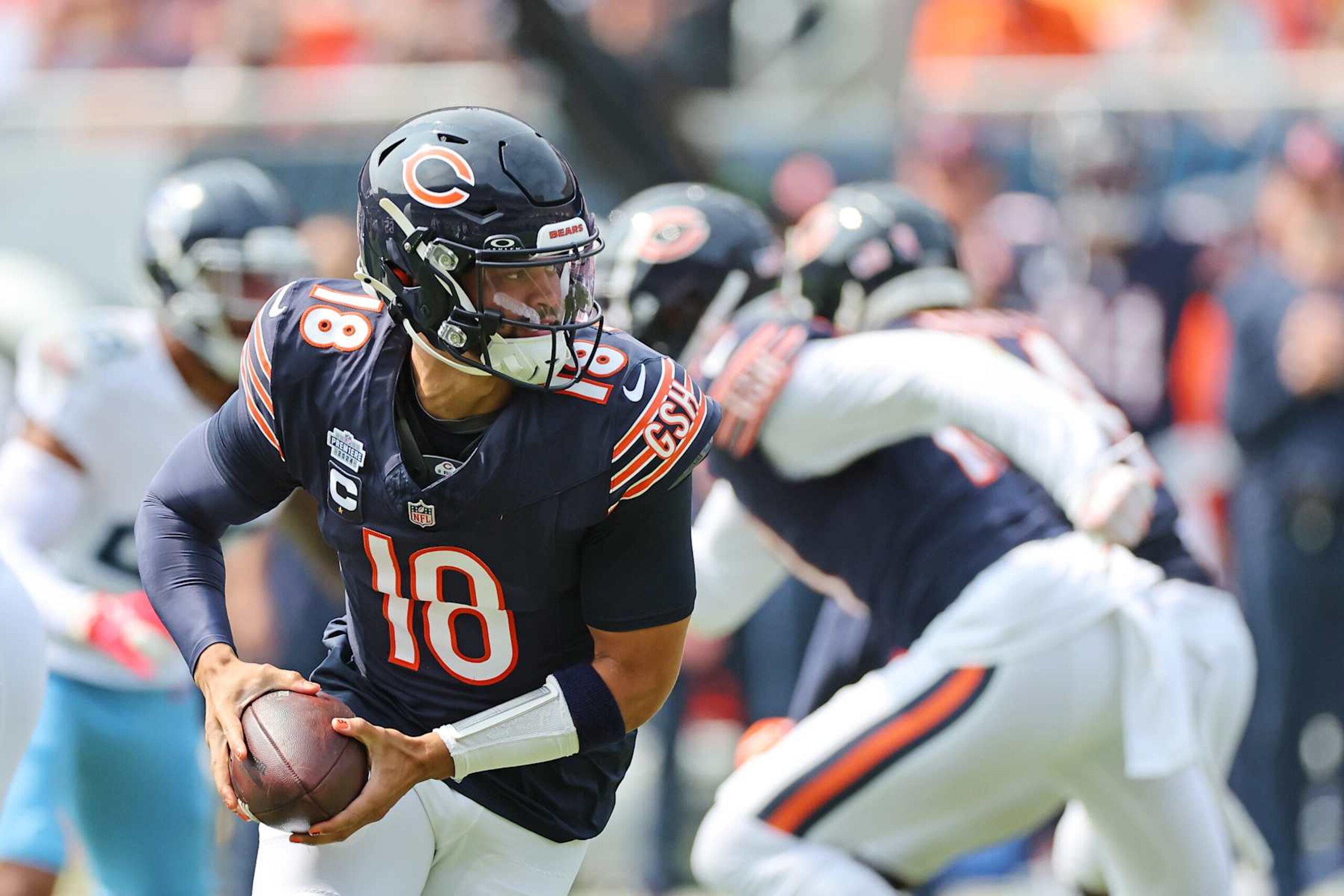 CHICAGO, ILLINOIS - SEPTEMBER 08: Caleb Williams #18 of the Chicago Bears looks to pass during a game against the Tennessee Titans at Soldier Field on September 08, 2024 in Chicago, Illinois.  The Bears defeated the Titans 24-17. (Photo by Stacy Revere/Getty Images)