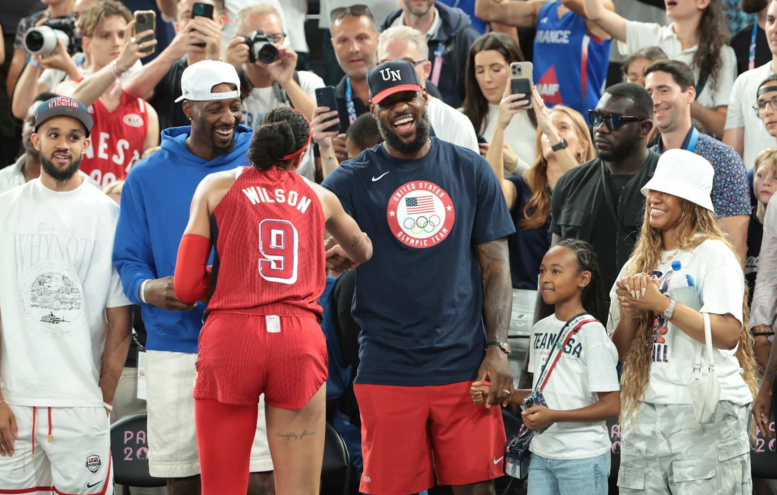 PARIS, FRANCE - AUGUST 11: Derrick White, Bam Adebayo, LeBron James of USA, his daughter Zhuri James and his wife Savannah James congratulates A'ja Wilson of USA following the victory of Team USA following the Basketball Women's Gold Medal match between Team France and Team USA on day sixteen of the Olympic Games Paris 2024 at Bercy Arena on August 11, 2024 in Paris, France. (Photo by Jean Catuffe/Getty Images) PARIS, FRANCE - AUGUST 11: Derrick White, Bam Adebayo, LeBron James of USA, his daughter Zhuri James and his wife Savannah James congratulates A'ja Wilson of USA following the victory of Team USA following the Basketball Women's Gold Medal match between Team France and Team USA on day sixteen of the Olympic Games Paris 2024 at Bercy Arena on August 11, 2024 in Paris, France. (Photo by Jean Catuffe/Getty Images)