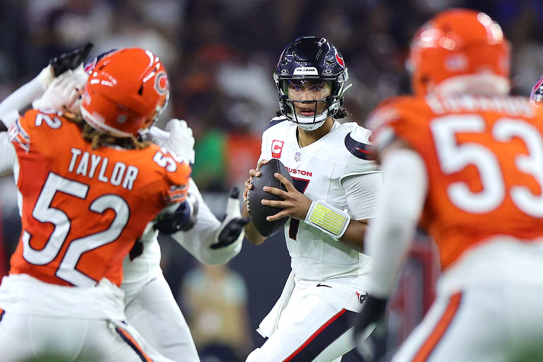 HOUSTON, TEXAS - SEPTEMBER 15: C.J. Stroud #7 of the Houston Texans looks to throw the ball as Darrell Taylor #52 of the Chicago Bears applies pressure during the first half at NRG Stadium on September 15, 2024 in Houston, Texas. (Photo by Alex Slitz/Getty Images)