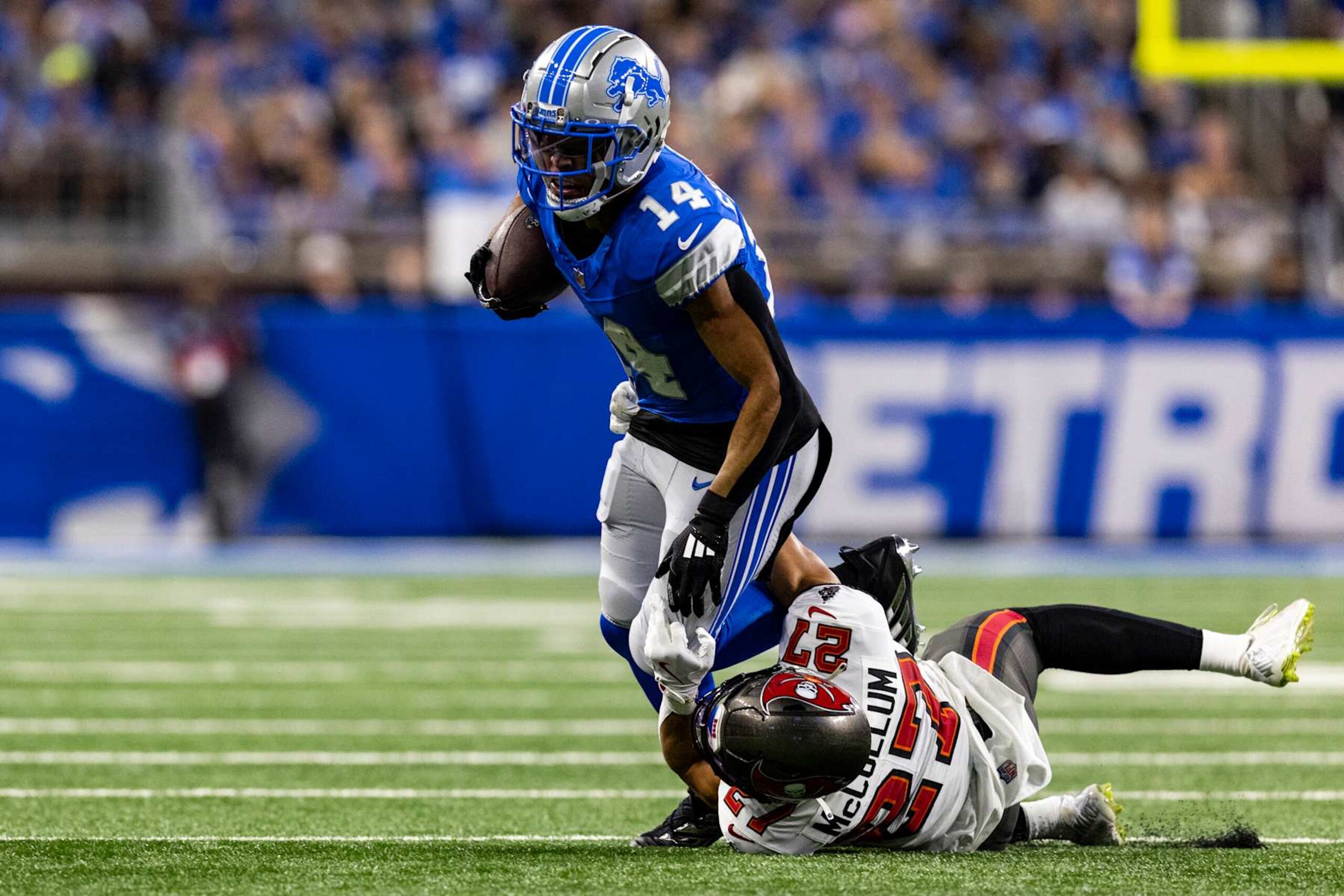 DETROIT, MICHIGAN - SEPTEMBER 15: Amon-Ra St. Brown #14 of the Detroit Lions is tackled by Zyon McCollum #27 of the Tampa Bay Buccaneers at Ford Field on September 15, 2024 in Detroit, Michigan. The Buccaneers beat the Lions 20-16. (Photo by Lauren Leigh Bacho/Getty Images)