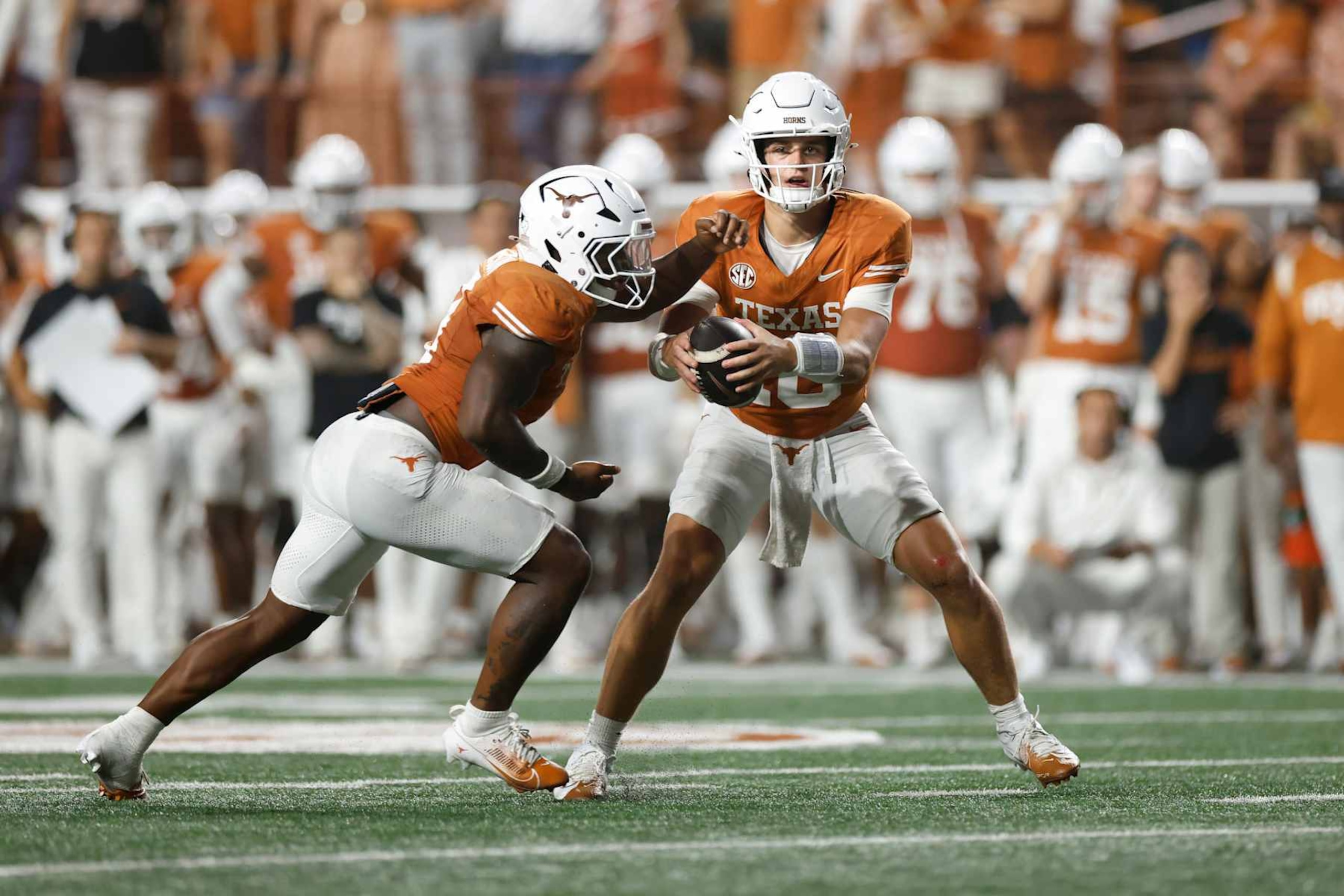 AUSTIN, TEXAS - SEPTEMBER 14: Arch Manning #16 of the Texas Longhorns fakes a handoff to Jerrick Gibson #9 and looks to pass in the second half against the UTSA Roadrunners at Darrell K Royal-Texas Memorial Stadium on September 14, 2024 in Austin, Texas. (Photo by Tim Warner/Getty Images)