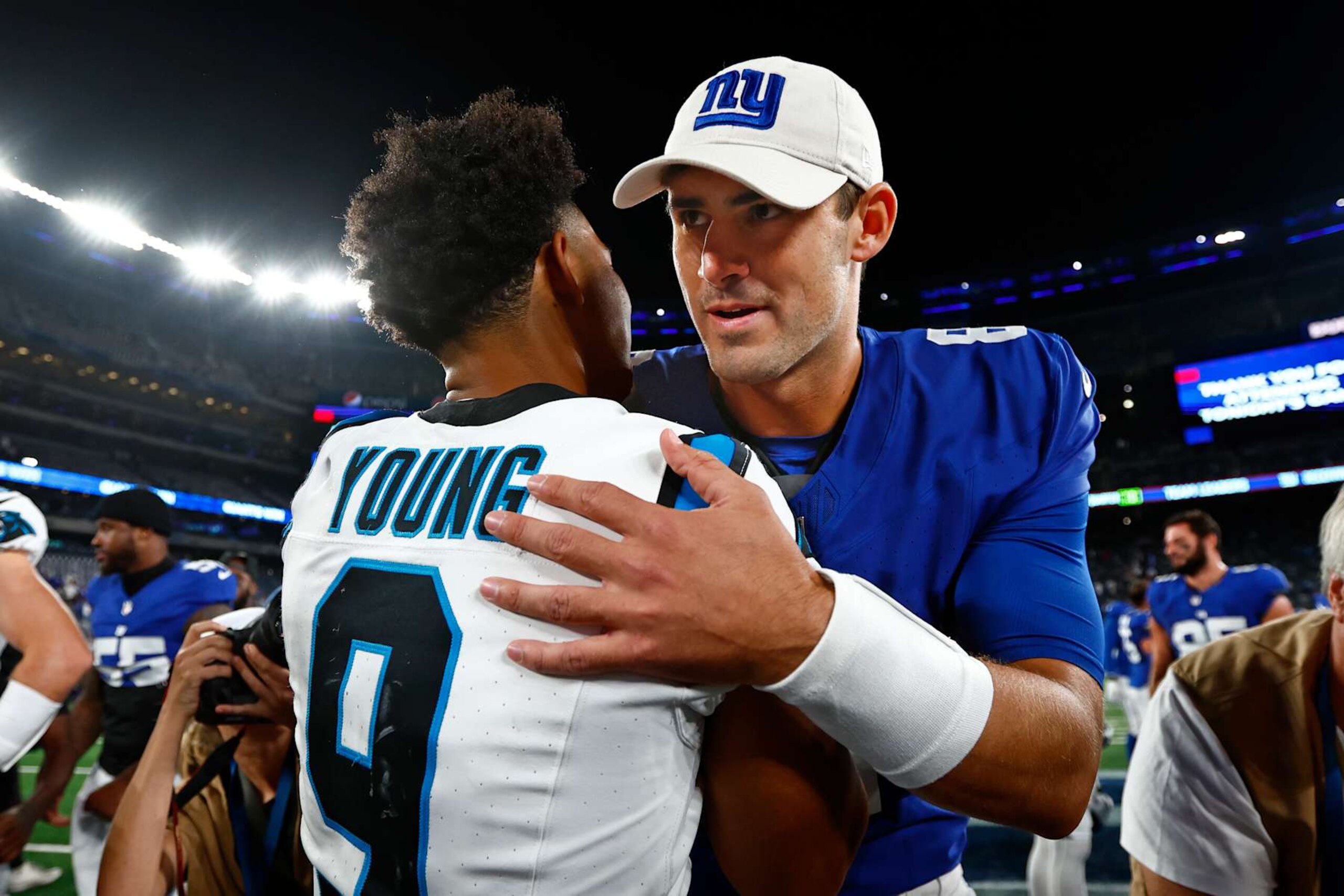 EAST RUTHERFORD, NEW JERSEY - AUGUST 18: Quarterbacks Bryce Young #9 of the Carolina Panthers and Daniel Jones #8 of the New York Giants hug after their preseason football game at MetLife Stadium on August 18, 2023 in East Rutherford, New Jersey. The Giants defeated the Giants 21-19. (Photo by Rich Schultz/Getty Images)