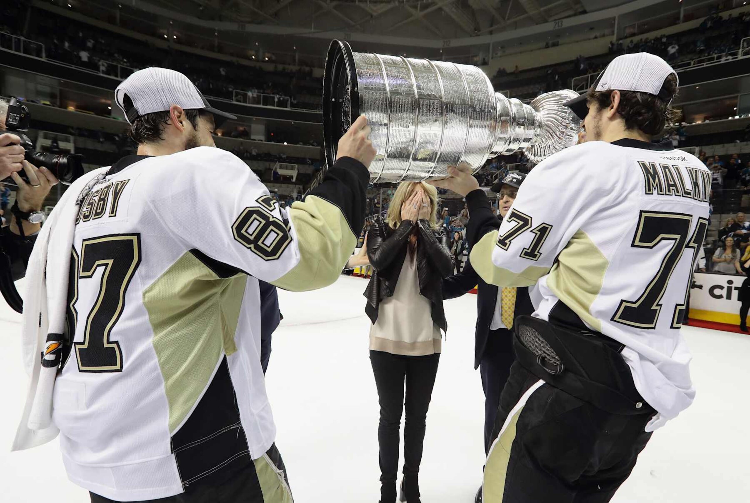 SAN JOSE, CA - JUNE 12: Sidney Crosby #87 and Evgeni Malkin #71 of the Pittsburgh Penguins carry the Stanley Cup to Nathalie Lemieux (wife of Mario) after defeating the San Jose Sharks in Game Six of the 2016 NHL Stanley Cup Final at SAP Center on June 12, 2016 in San Jose, California. (Photo by Bruce Bennett/Getty Images) SAN JOSE, CA - JUNE 12: Sidney Crosby #87 and Evgeni Malkin #71 of the Pittsburgh Penguins carry the Stanley Cup to Nathalie Lemieux (wife of Mario) after defeating the San Jose Sharks in Game Six of the 2016 NHL Stanley Cup Final at SAP Center on June 12, 2016 in San Jose, California. (Photo by Bruce Bennett/Getty Images)