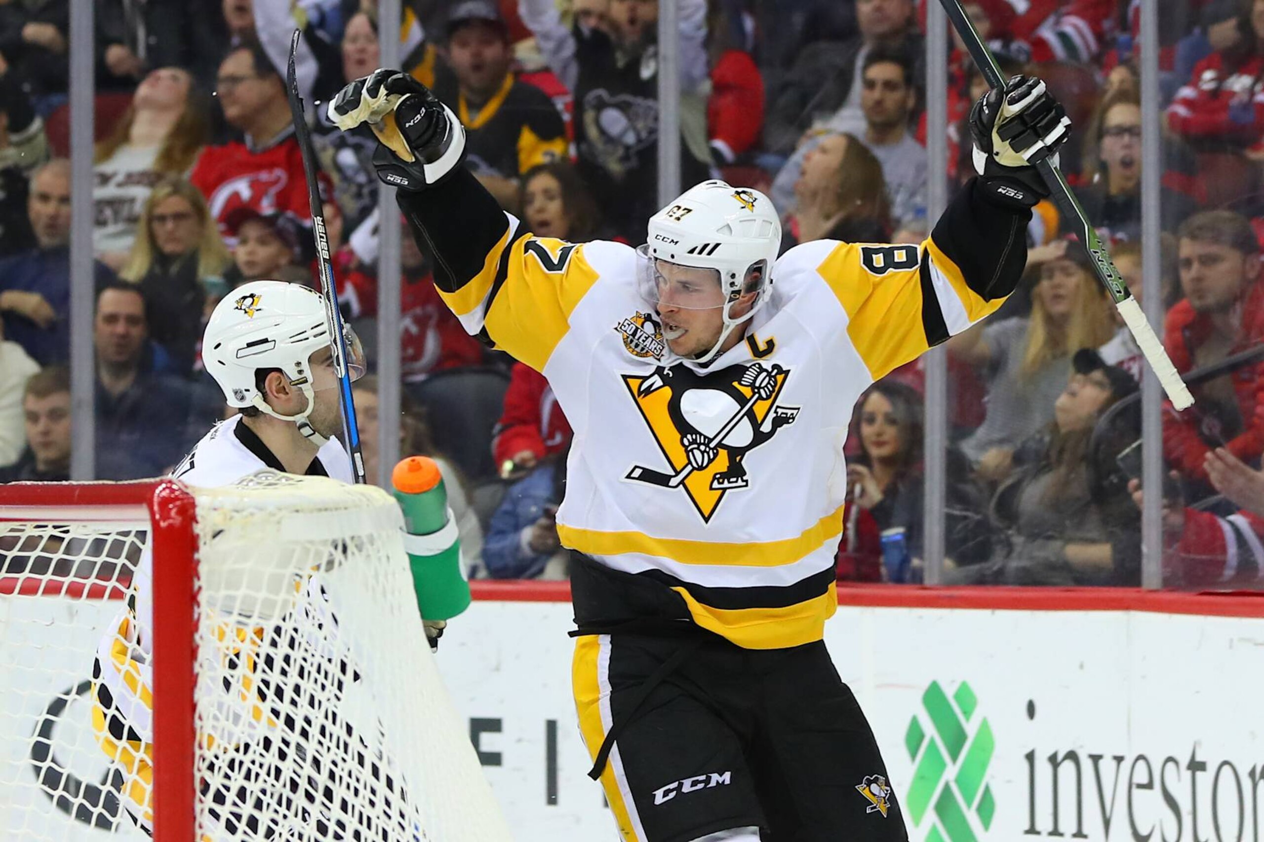NEWARK, NJ - DECEMBER 27: Pittsburgh Penguins defenseman Justin Schultz (4) celebrates with teammate Pittsburgh Penguins center Sidney Crosby (87) after scoring during the second period of the National Hockey League game between the New Jersey Devils and the Pittsburgh Penguins on December 27, 2016, at the Prudential Center in Newark, NJ. (Photo by Rich Graessle/Icon Sportswire via Getty Images) NEWARK, NJ - DECEMBER 27: Pittsburgh Penguins defenseman Justin Schultz (4) celebrates with teammate Pittsburgh Penguins center Sidney Crosby (87) after scoring during the second period of the National Hockey League game between the New Jersey Devils and the Pittsburgh Penguins on December 27, 2016, at the Prudential Center in Newark, NJ. (Photo by Rich Graessle/Icon Sportswire via Getty Images)
