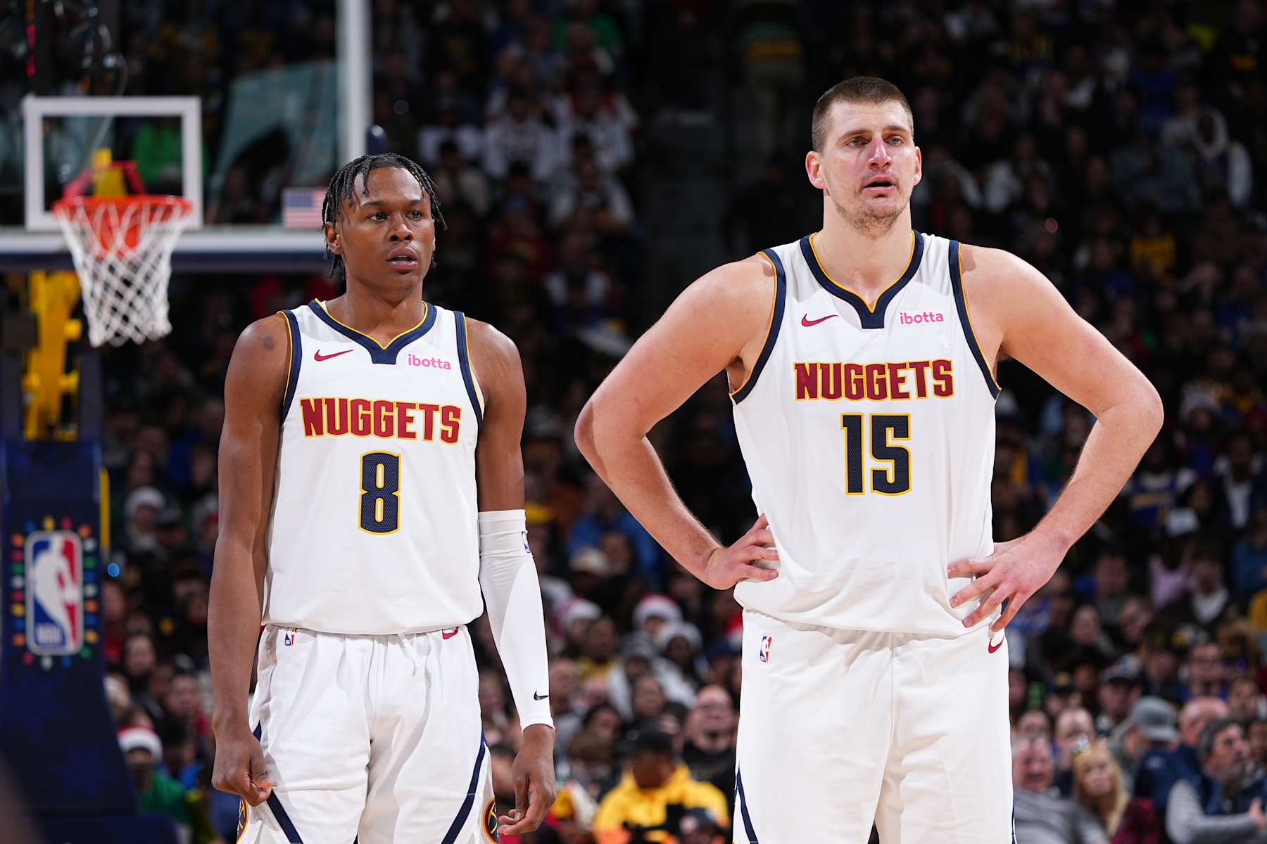 DENVER, CO - DECEMBER 25: Peyton Watson #8 and Nikola Jokic #15 of the Denver Nuggets looks on during the game against the Golden State Warriors on December 25, 2023 at the Ball Arena in Denver, Colorado. NOTE TO USER: User expressly acknowledges and agrees that, by downloading and/or using this Photograph, user is consenting to the terms and conditions of the Getty Images License Agreement. Mandatory Copyright Notice: Copyright 2023 NBAE (Photo by Garrett Ellwood/NBAE via Getty Images)