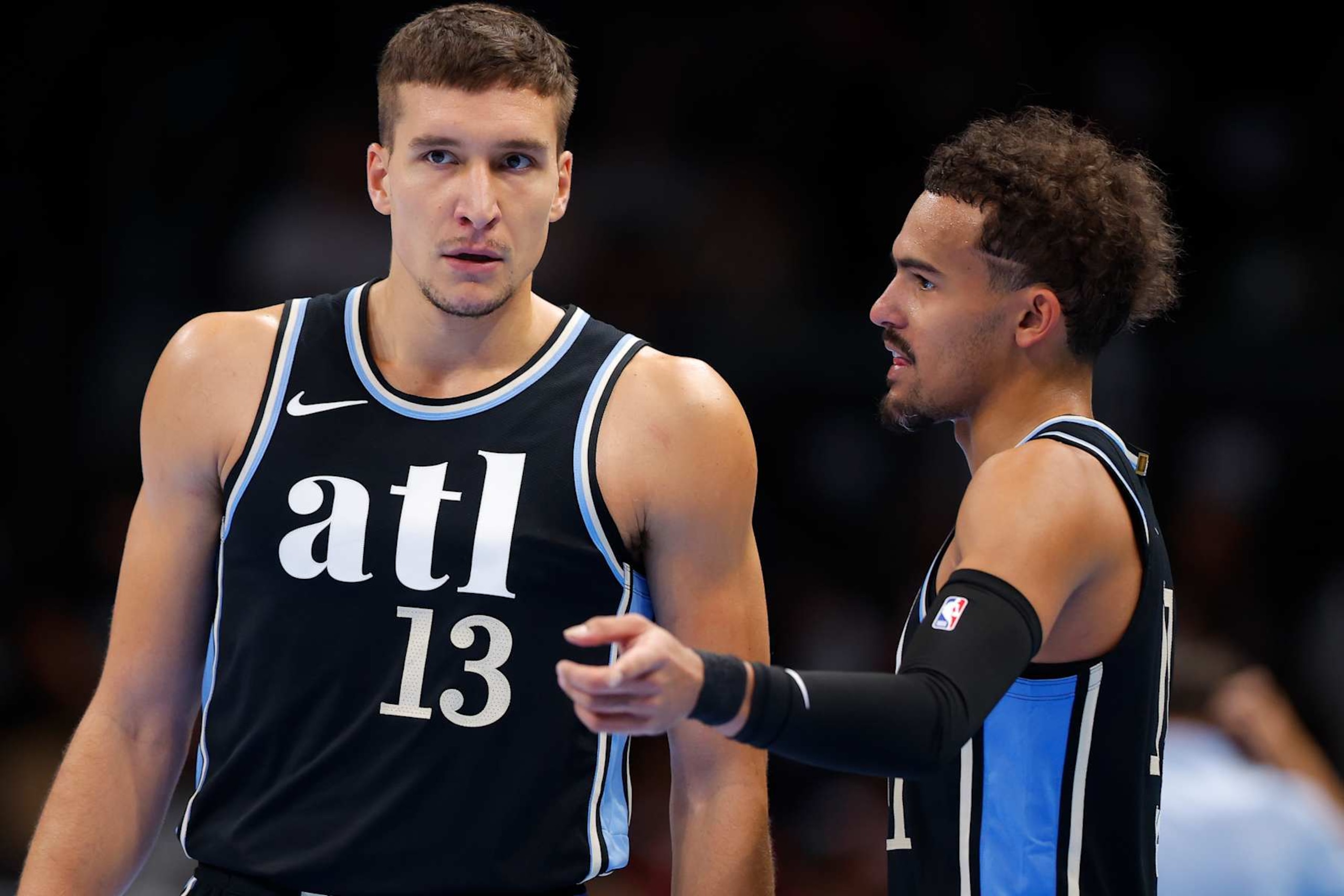 ATLANTA, GEORGIA - NOVEMBER 17: Bogdan Bogdanovic #13 speaks with Trae Young #11 of the Atlanta Hawks during the second half against the Philadelphia 76ers during an NBA In-Season Tournament game at State Farm Arena on November 17, 2023 in Atlanta, Georgia. NOTE TO USER: User expressly acknowledges and agrees that, by downloading and or using this photograph, User is consenting to the terms and conditions of the Getty Images License Agreement. (Photo by Todd Kirkland/Getty Images)