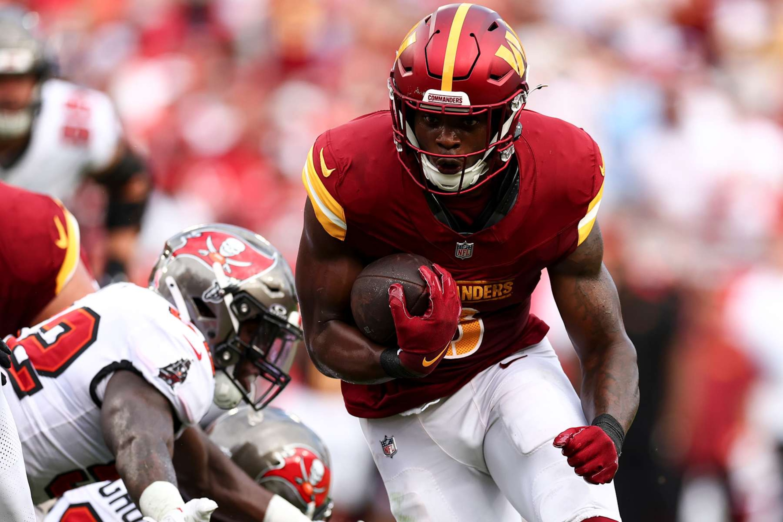 TAMPA, FL - SEPTEMBER 8: Brian Robinson Jr. #8 of the Washington Commanders carries the ball during the second quarter of an NFL football game against the Tampa Bay Buccaneers at Raymond James Stadium on September 8, 2024 in Tampa, Florida. (Photo by Kevin Sabitus/Getty Images)