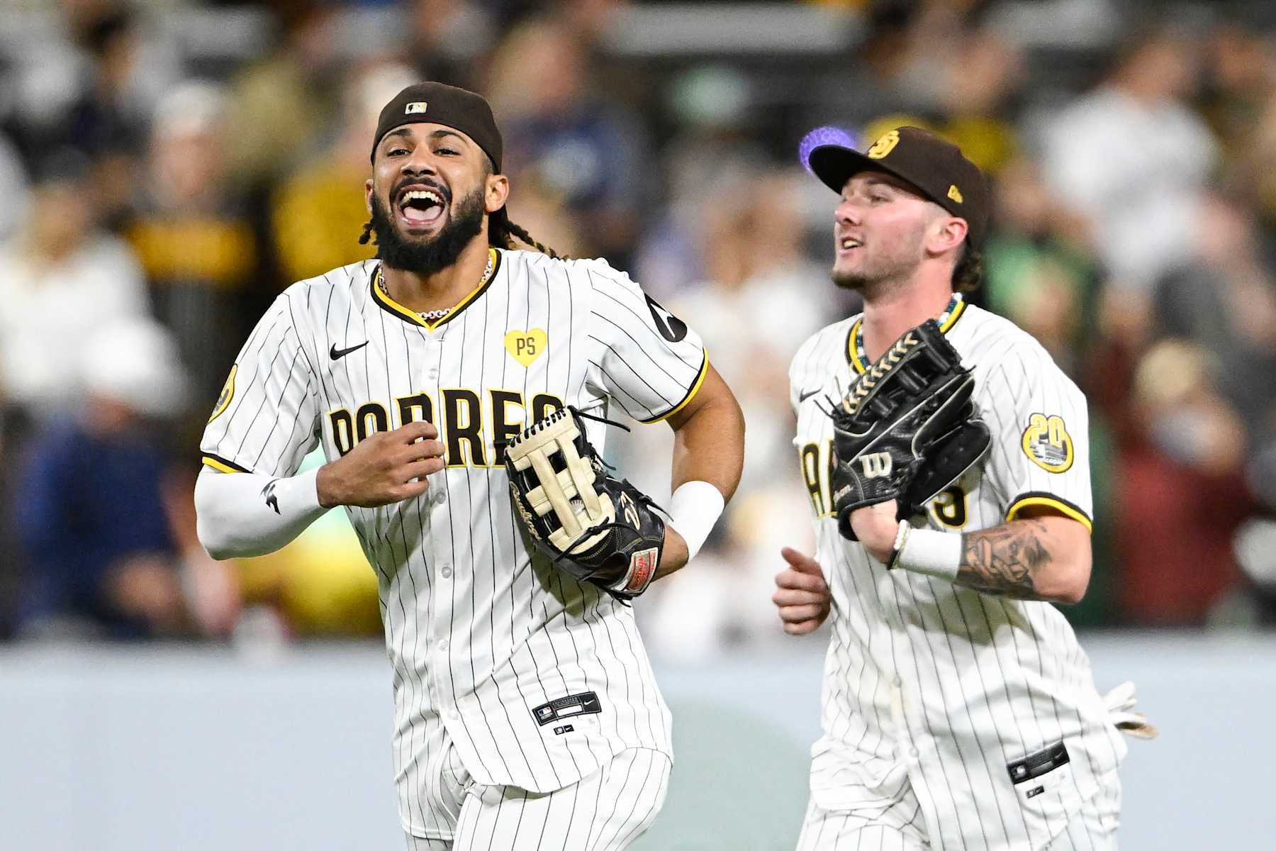 SAN DIEGO, CA - SEPTEMBER 16: Fernando Tatis Jr. #23 of the San Diego Padres, left, and Jackson Merrill #3 celebrate after the Padres beat the Houston Astros 3-1 in a baseball game September 16, 2024 at Petco Park in San Diego, California. (Photo by Denis Poroy/Getty Images)