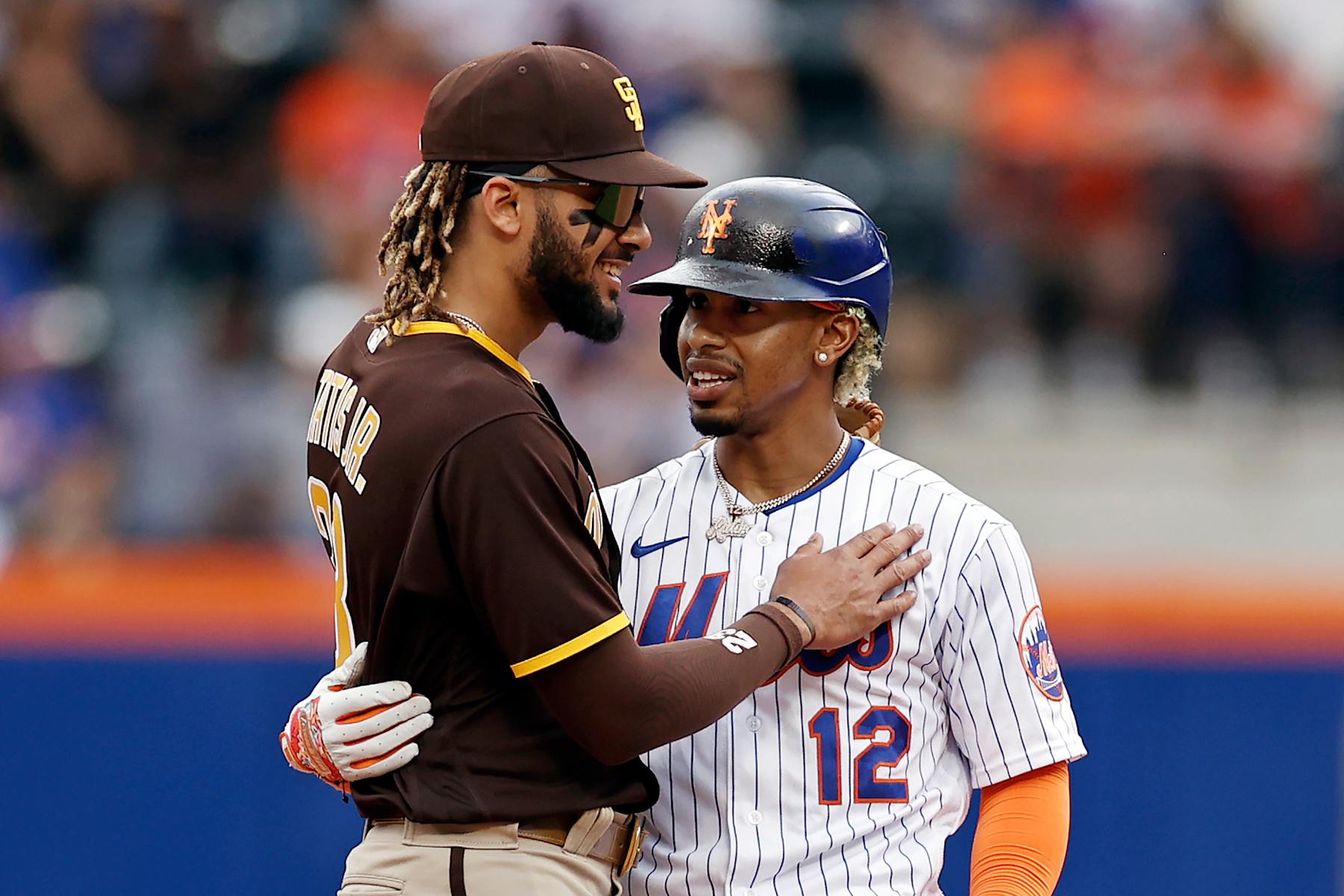 NEW YORK, NY - JUNE 13: Francisco Lindor #12 of the New York Mets embraces Fernando Tatis Jr. #23 of the San Diego Padres after hitting a double during the fourth inning at Citi Field on June 13, 2021 in the Flushing neighborhood of the Queens borough of New York City. (Photo by Adam Hunger/Getty Images)