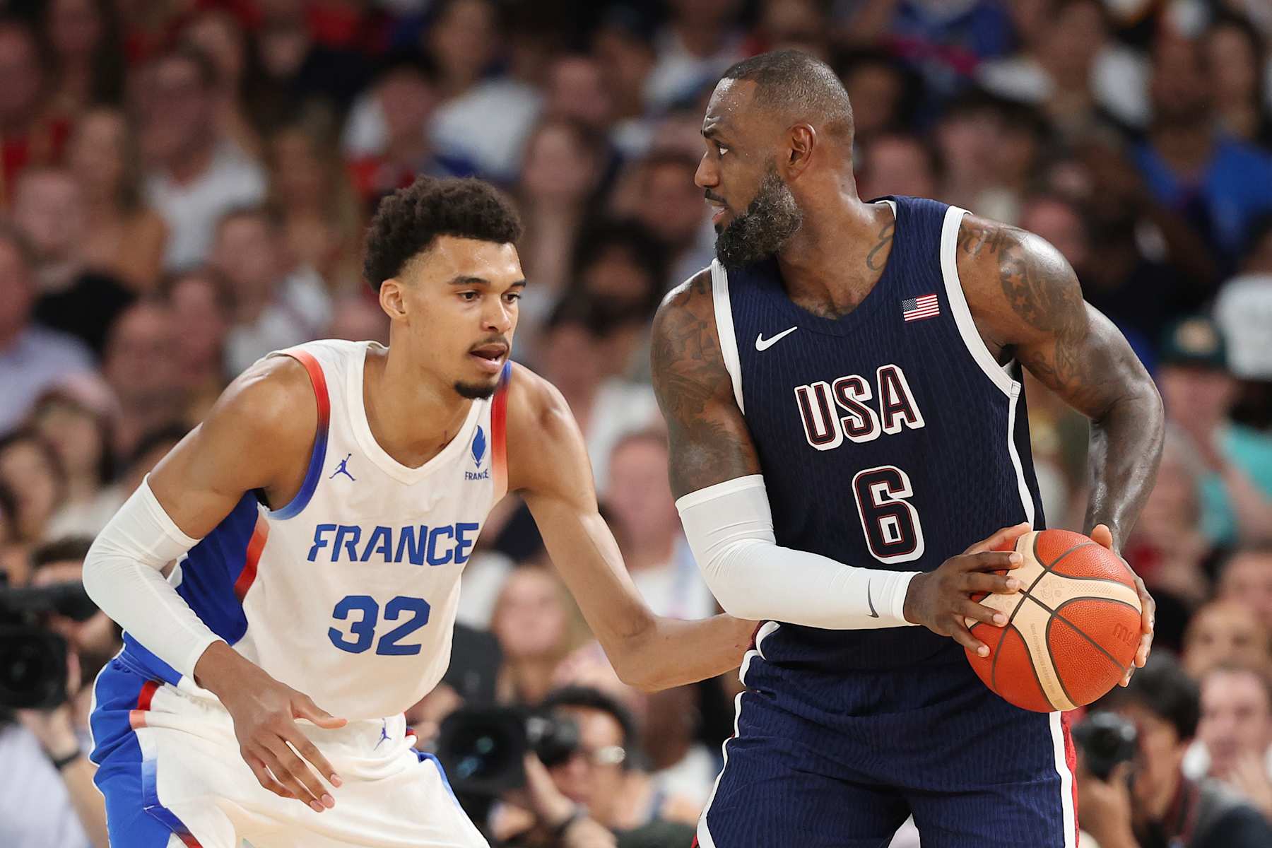 PARIS, FRANCE - AUGUST 10: Victor Wembanyama #32 of Team France defends LeBron James #6 of Team United States during the Men's Gold Medal game between Team France and Team United States on day fifteen of the Olympic Games Paris 2024 at Bercy Arena on August 10, 2024 in Paris, France. (Photo by Michael Reaves/Getty Images)