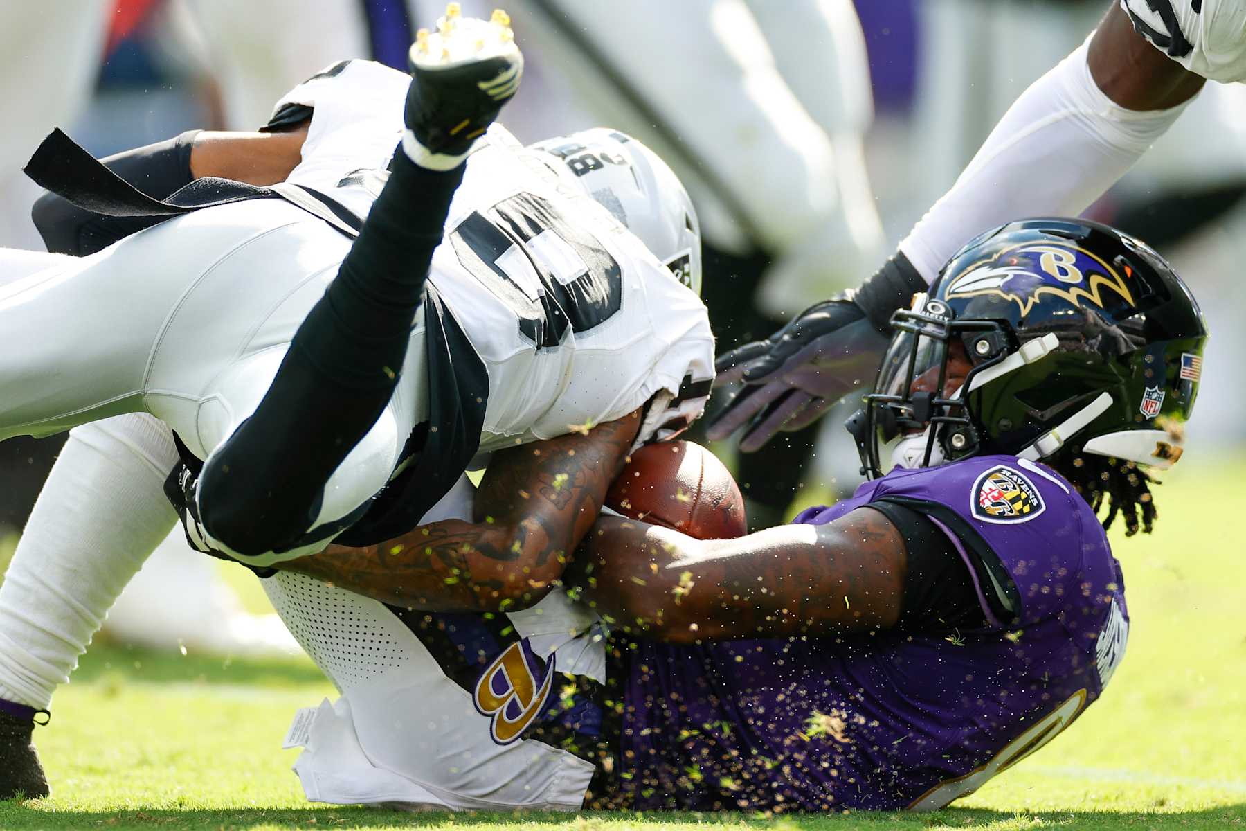 BALTIMORE, MARYLAND - SEPTEMBER 15: Jack Jones #18 of the Las Vegas Raiders tackles Lamar Jackson #8 of the Baltimore Ravens during the second half at M&T Bank Stadium on September 15, 2024 in Baltimore, Maryland. (Photo by Brandon Sloter/Getty Images)