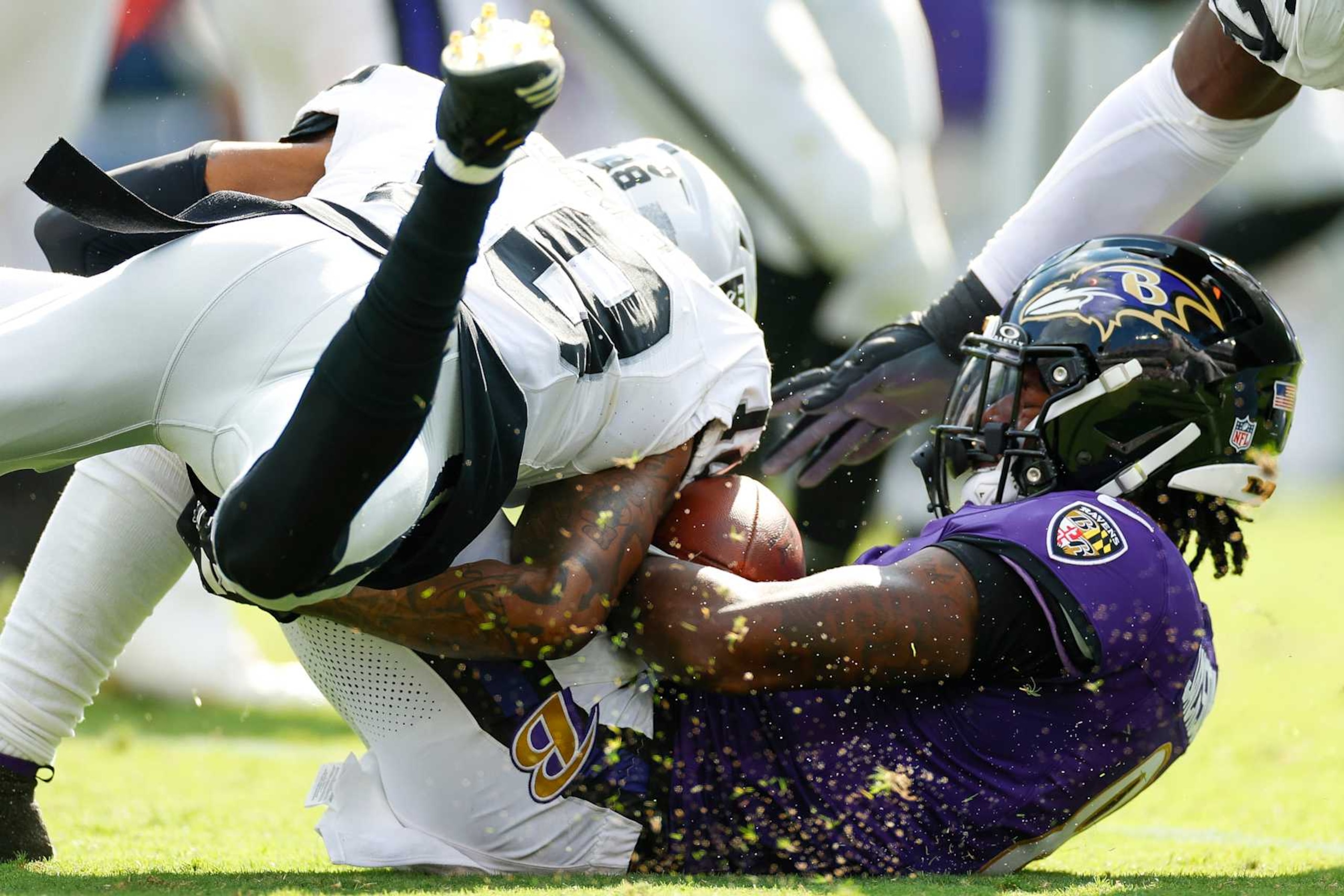 BALTIMORE, MARYLAND - SEPTEMBER 15: Jack Jones #18 of the Las Vegas Raiders tackles Lamar Jackson #8 of the Baltimore Ravens during the second half at M&T Bank Stadium on September 15, 2024 in Baltimore, Maryland. (Photo by Brandon Sloter/Getty Images)