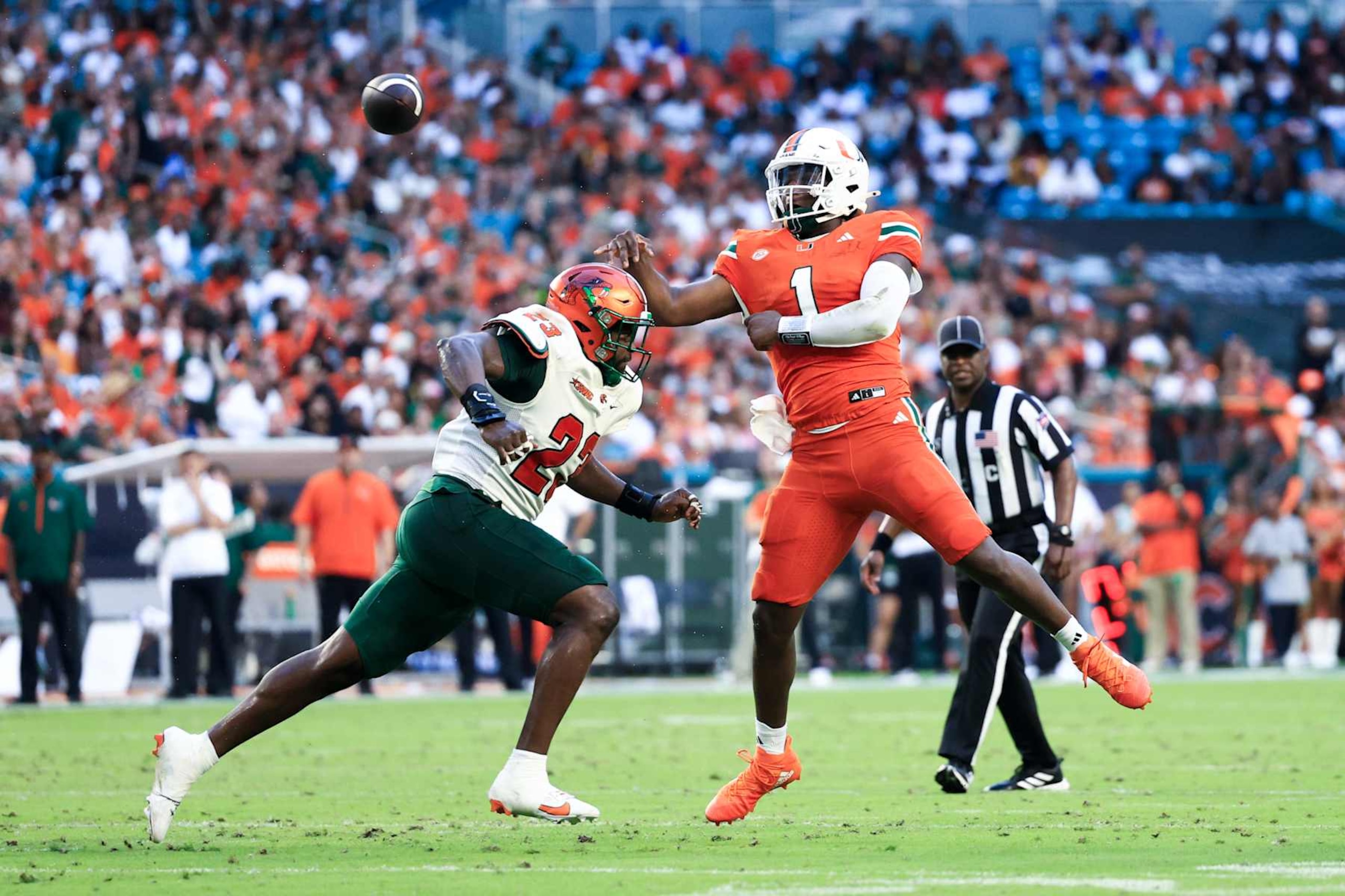 MIAMI GARDENS, FLORIDA - SEPTEMBER 07: Quarterback Cam Ward #1 of the Miami Hurricanes throws a pass over defender defensive lineman Allen Smith Jr. #23 of the Florida A&M Rattlers during the first half at Hard Rock Stadium on September 07, 2024 in Miami Gardens, Florida. (Photo by Carmen Mandato/Getty Images) MIAMI GARDENS, FLORIDA - SEPTEMBER 07: Quarterback Cam Ward #1 of the Miami Hurricanes throws a pass over defender defensive lineman Allen Smith Jr. #23 of the Florida A&M Rattlers during the first half at Hard Rock Stadium on September 07, 2024 in Miami Gardens, Florida. (Photo by Carmen Mandato/Getty Images)