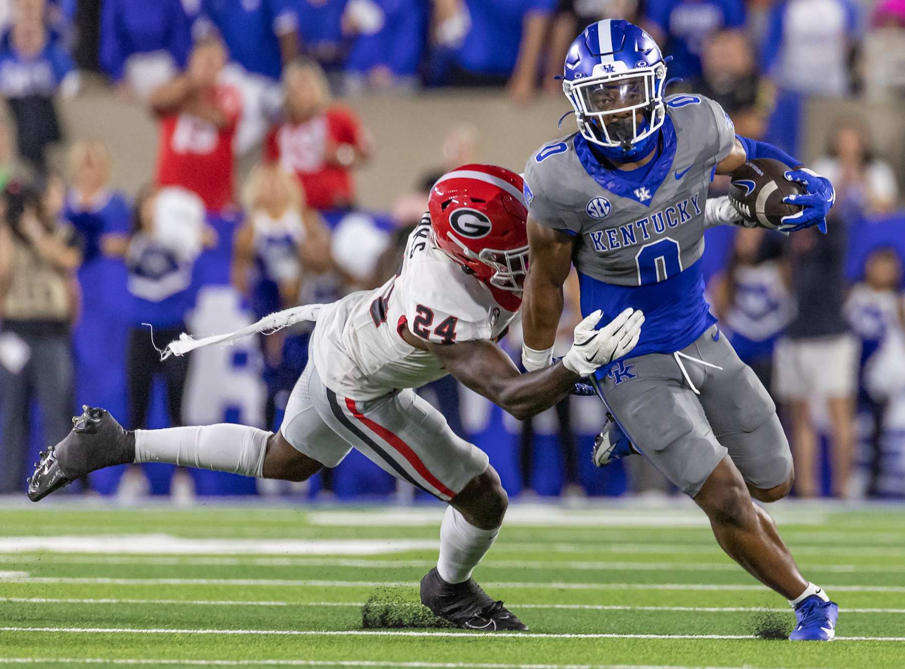 LEXINGTON, KENTUCKY - SEPTEMBER 14: Demie Sumo-Karngbaye #0 of the Kentucky Wildcats runs the ball as Malaki Starks #24 of the Georgia Bulldogs attempts the tackle during the first half at Kroger Field on September 14, 2024 in Lexington, Kentucky. (Photo by Michael Hickey/Getty Images)