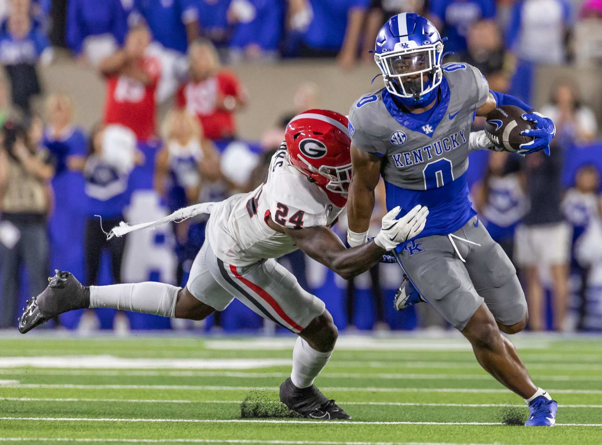 LEXINGTON, KENTUCKY - SEPTEMBER 14: Demie Sumo-Karngbaye #0 of the Kentucky Wildcats runs the ball as Malaki Starks #24 of the Georgia Bulldogs attempts the tackle during the first half at Kroger Field on September 14, 2024 in Lexington, Kentucky. (Photo by Michael Hickey/Getty Images) LEXINGTON, KENTUCKY - SEPTEMBER 14: Demie Sumo-Karngbaye #0 of the Kentucky Wildcats runs the ball as Malaki Starks #24 of the Georgia Bulldogs attempts the tackle during the first half at Kroger Field on September 14, 2024 in Lexington, Kentucky. (Photo by Michael Hickey/Getty Images)