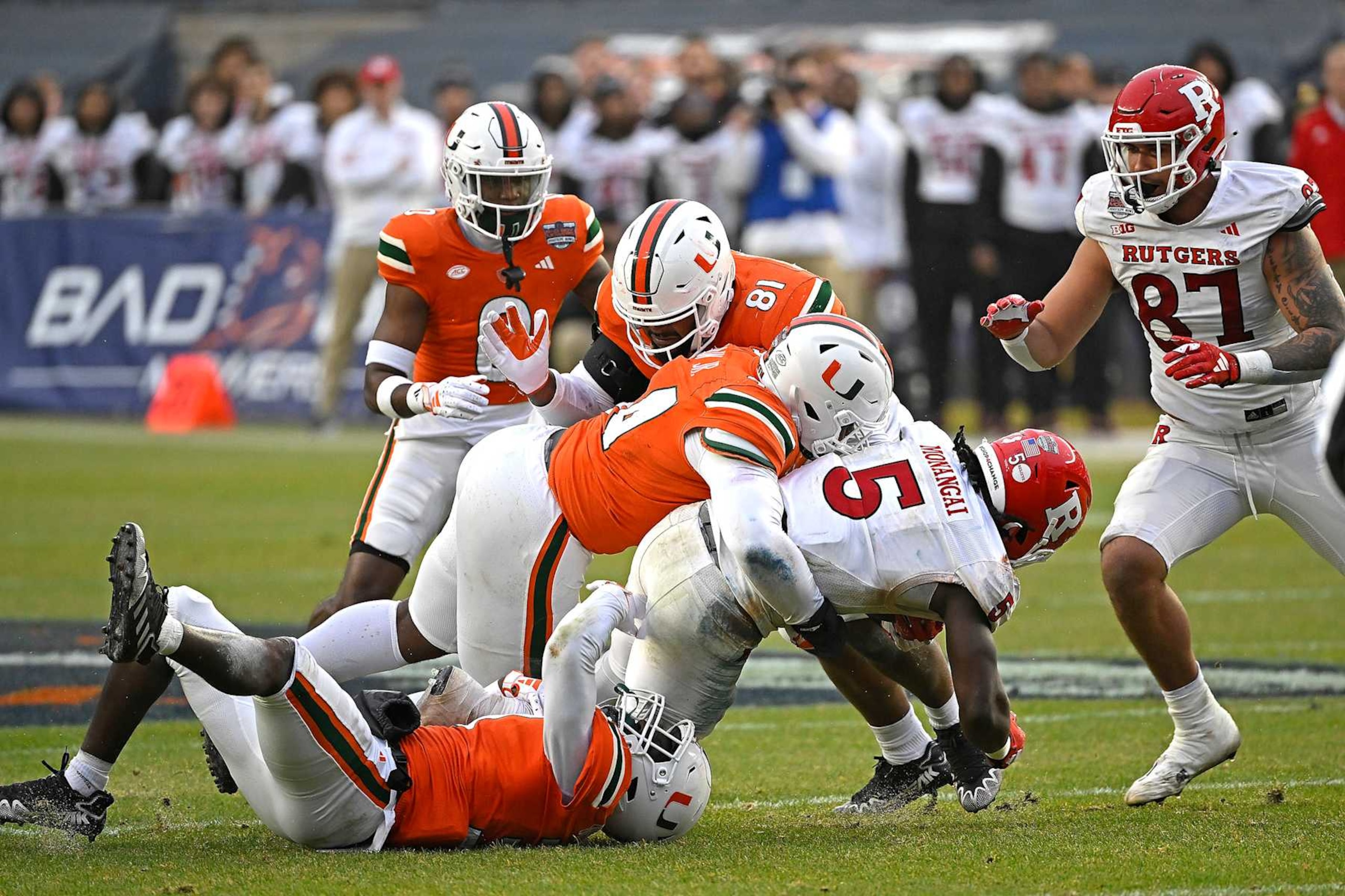 MIAMI GARDENS, FL - DECEMBER 28: Miami defensive lineman Rueben Bain, Jr. (44) and linebacker Wesley Bissainthe (31) combine to stop Rutgers running back Kyle Monangai (5) in the second quarter as the Miami Hurricanes faced the Rutgers Scarlett Knights on December 28, 2023, at Yankee Stadium in New York, New York. (Photo by Samuel Lewis/Icon Sportswire via Getty Images) MIAMI GARDENS, FL - DECEMBER 28: Miami defensive lineman Rueben Bain, Jr. (44) and linebacker Wesley Bissainthe (31) combine to stop Rutgers running back Kyle Monangai (5) in the second quarter as the Miami Hurricanes faced the Rutgers Scarlett Knights on December 28, 2023, at Yankee Stadium in New York, New York. (Photo by Samuel Lewis/Icon Sportswire via Getty Images)