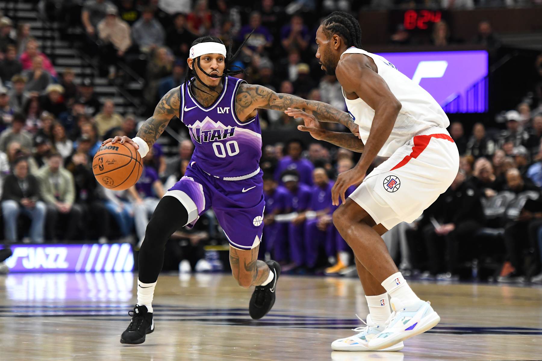 SALT LAKE CITY, UTAH - DECEMBER 08: Jordan Clarkson #00 of the Utah Jazz drives into Kawhi Leonard #2 of the LA Clippers during the first half of a game at Delta Center on December 08, 2023 in Salt Lake City, Utah. NOTE TO USER: User expressly acknowledges and agrees that, by downloading and or using this photograph, User is consenting to the terms and conditions of the Getty Images License Agreement. (Photo by Alex Goodlett/Getty Images)