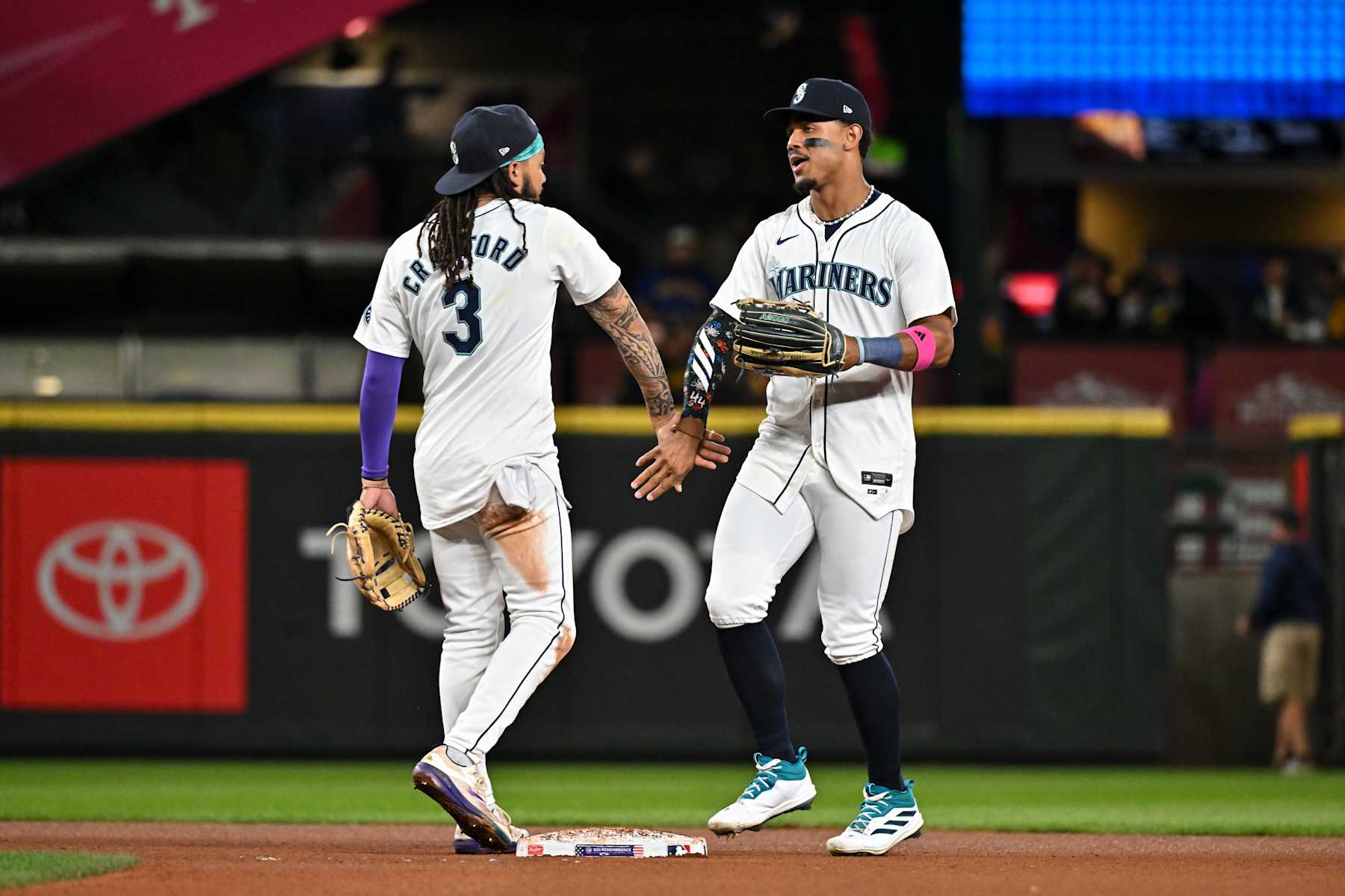 SEATTLE, WASHINGTON - SEPTEMBER 11: J.P. Crawford #3 and Julio Rodriguez #44 of the Seattle Mariners shakes hands after the game against the San Diego Padres at T-Mobile Park on September 11, 2024 in Seattle, Washington. The Seattle Mariners won 5-2. (Photo by Alika Jenner/Getty Images)