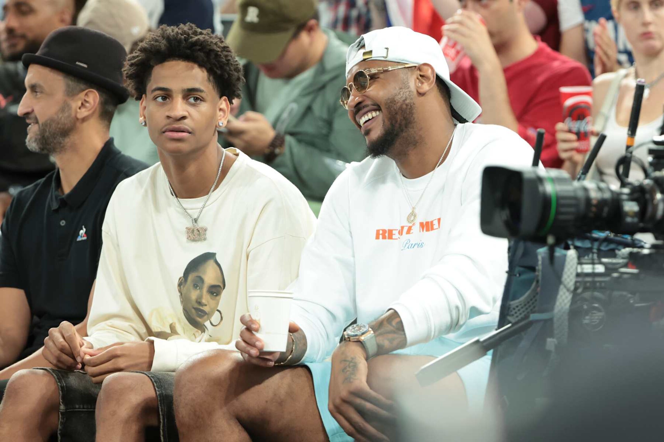 PARIS, FRANCE - AUGUST 8: Carmelo Anthony and his son Kiyan Anthony (left) attend the Men's Basketball semifinal game between Team France and Team Germany on day thirteen of the Olympic Games Paris 2024 at Bercy Arena on August 8, 2024 in Paris, France. (Photo by Jean Catuffe/Getty Images)