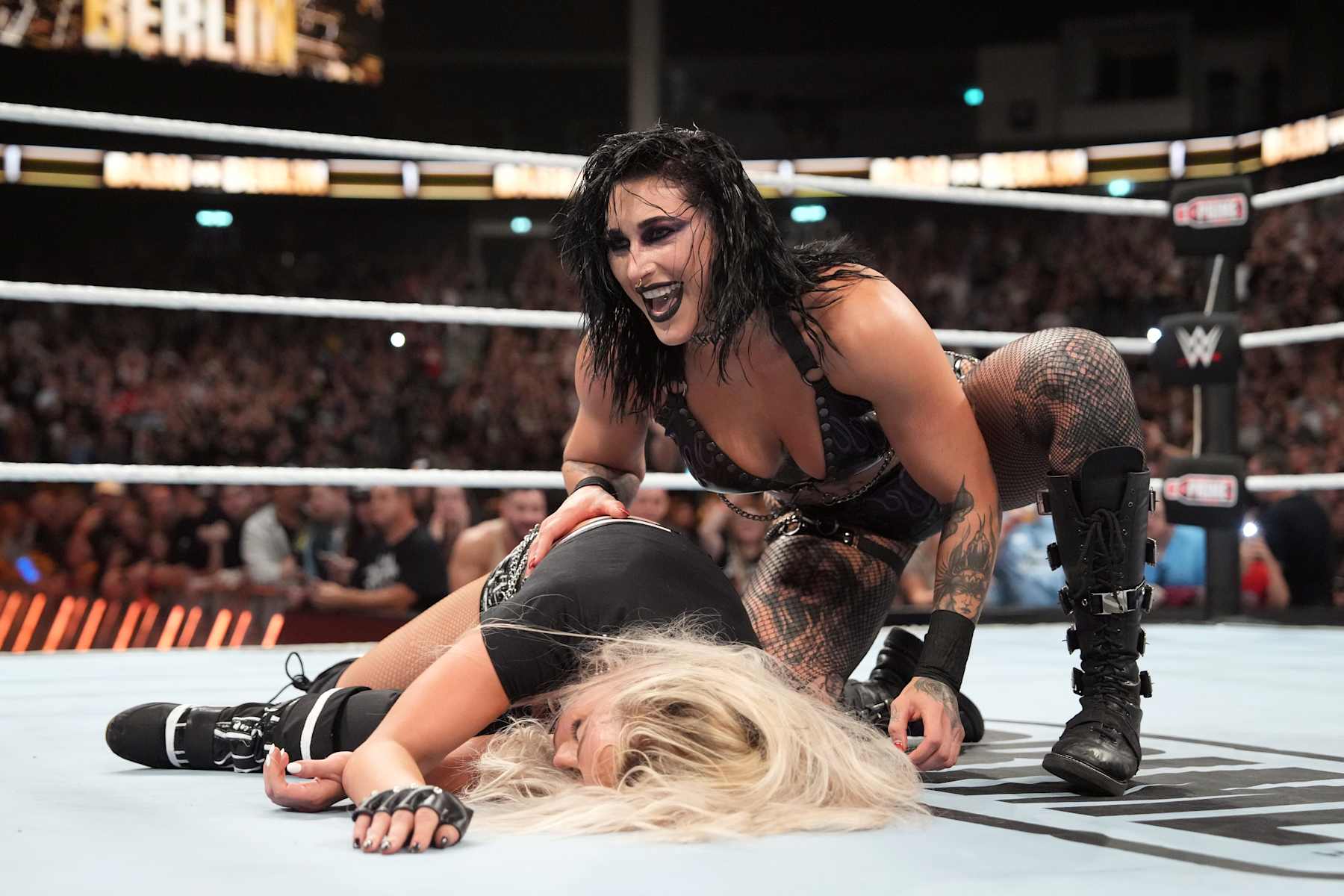 BERLIN, GERMANY - AUGUST 31: Rhea Ripley kneels over WWE Women's World Champion Liv Morgan after Ripley pinned her during the WWE Bash in Berlin Premium Live Event at Uber Arena on August 31, 2024 in Berlin, Germany.  (Photo by WWE/Getty Images)
