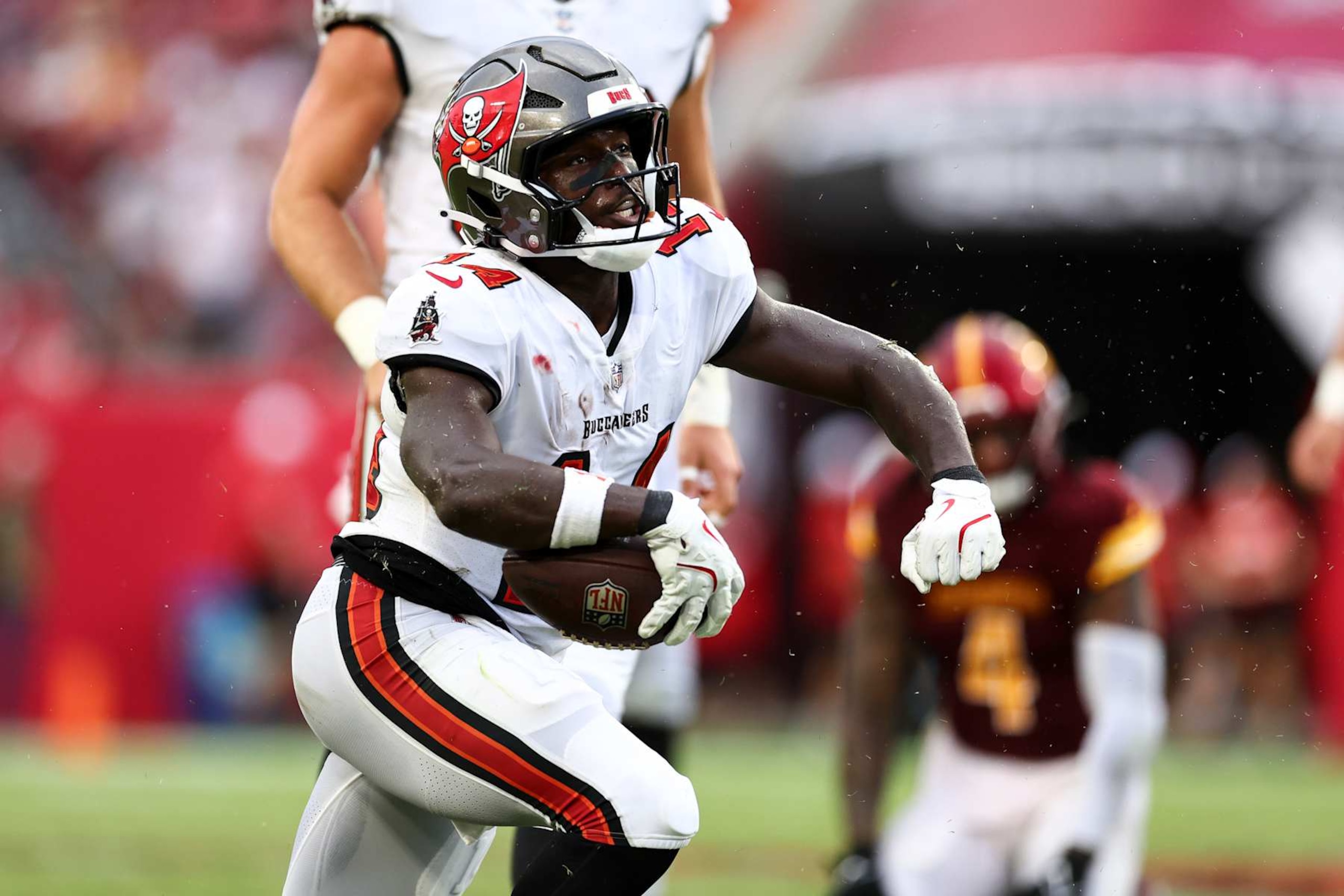 TAMPA, FL - SEPTEMBER 8: Chris Godwin #14 of the Tampa Bay Buccaneers celebrates after a play during the fourth quarter of an NFL football game against the Washington Commanders at Raymond James Stadium on September 8, 2024 in Tampa, Florida. (Photo by Kevin Sabitus/Getty Images)