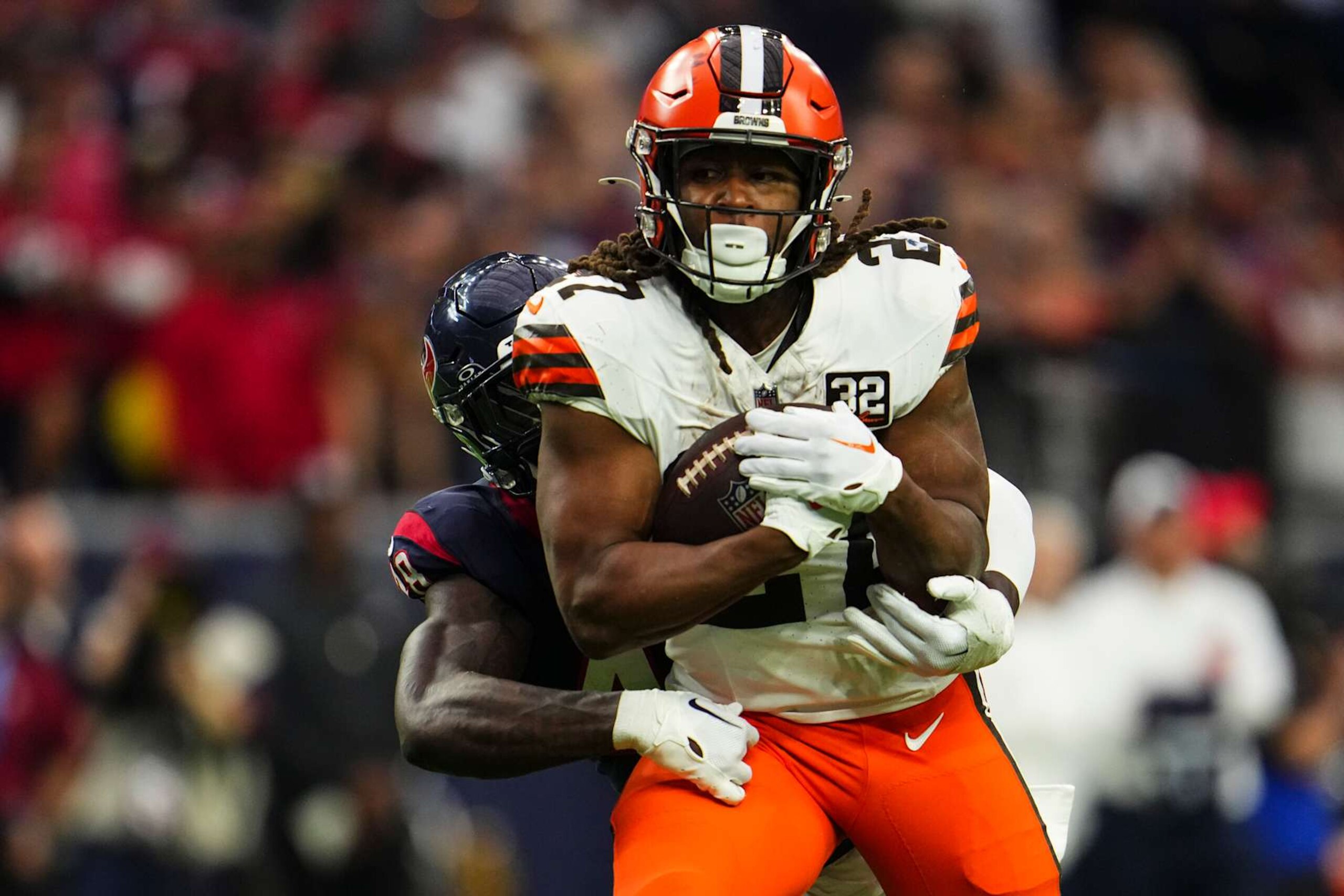HOUSTON, TX - JANUARY 13: Kareem Hunt #27 of the Cleveland Browns runs the ball during an NFL wild-card playoff football game against the Houston Texans at NRG Stadium on January 13, 2024 in Houston, Texas. (Photo by Cooper Neill/Getty Images)