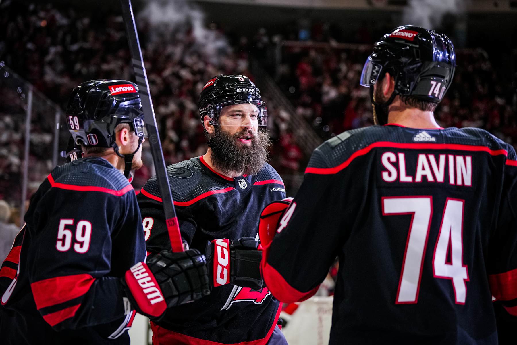 Carolina Hurricanes defensemen Brent Burns (center) and Jaccob Slavin. 