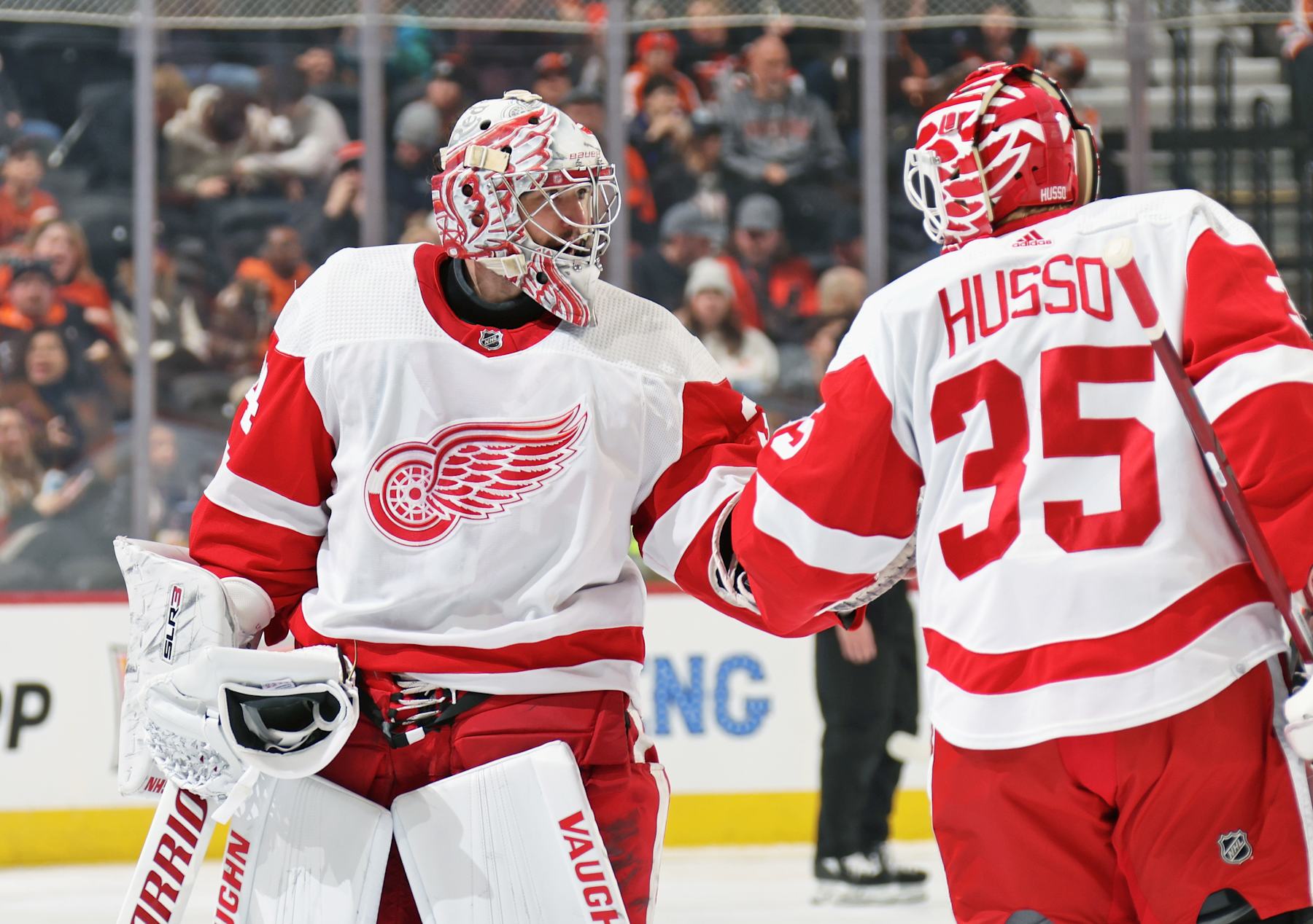PHILADELPHIA, PENNSYLVANIA - DECEMBER 16: Ville Husso #35 of the Detroit Red Wings greets teammate Alex Lyon #34 as Lyon exits the ice surface during the second period against the Philadelphia Flyers at the Wells Fargo Center on December 16, 2023 in Philadelphia, Pennsylvania.  (Photo by Len Redkoles/NHLI via Getty Images)