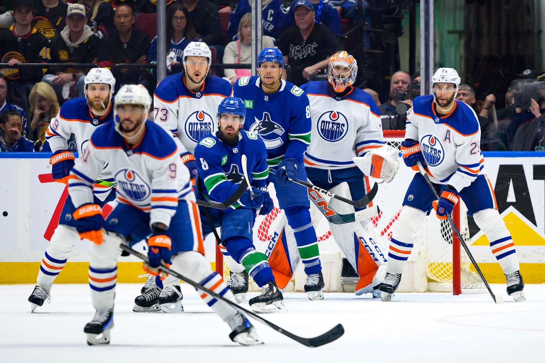 VANCOUVER, CANADA - MAY 20: Vincent Desharnais #73 and Darnell Nurse #25 of the Edmonton Oilers defend against Conor Garland #8 and Dakota Joshua #81 of the Vancouver Canucks during the second period in Game Seven of the Second Round of the 2024 Stanley Cup Playoffs at Rogers Arena on May 20, 2024 in Vancouver, British Columbia, Canada. (Photo by Derek Cain/Getty Images)