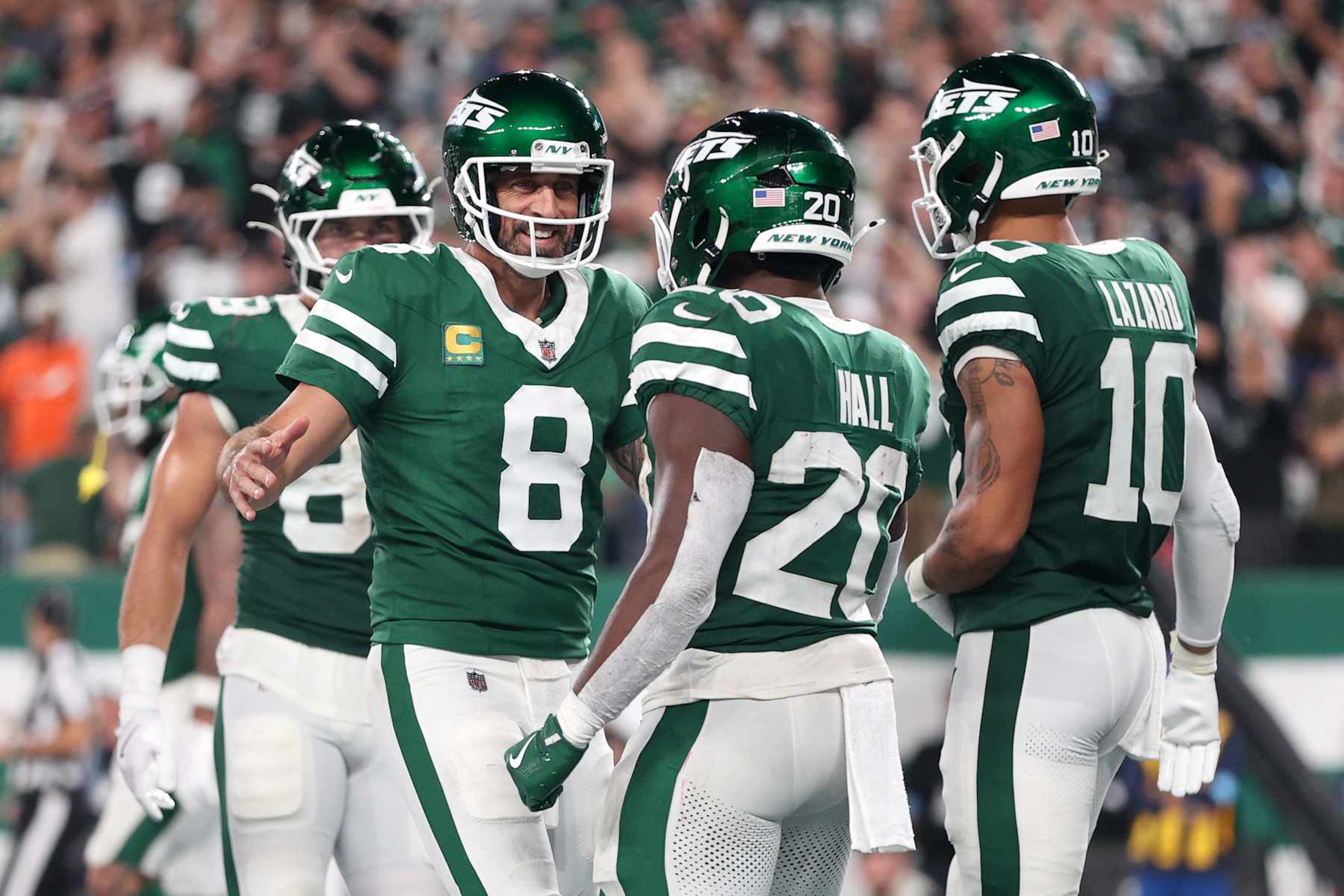 EAST RUTHERFORD, NEW JERSEY - SEPTEMBER 19: Aaron Rodgers #8 and Breece Hall #20 of the New York Jets celebrate a touchdown against the New England Patriots during the third quarter in the game at MetLife Stadium on September 19, 2024 in East Rutherford, New Jersey. (Photo by Sarah Stier/Getty Images)