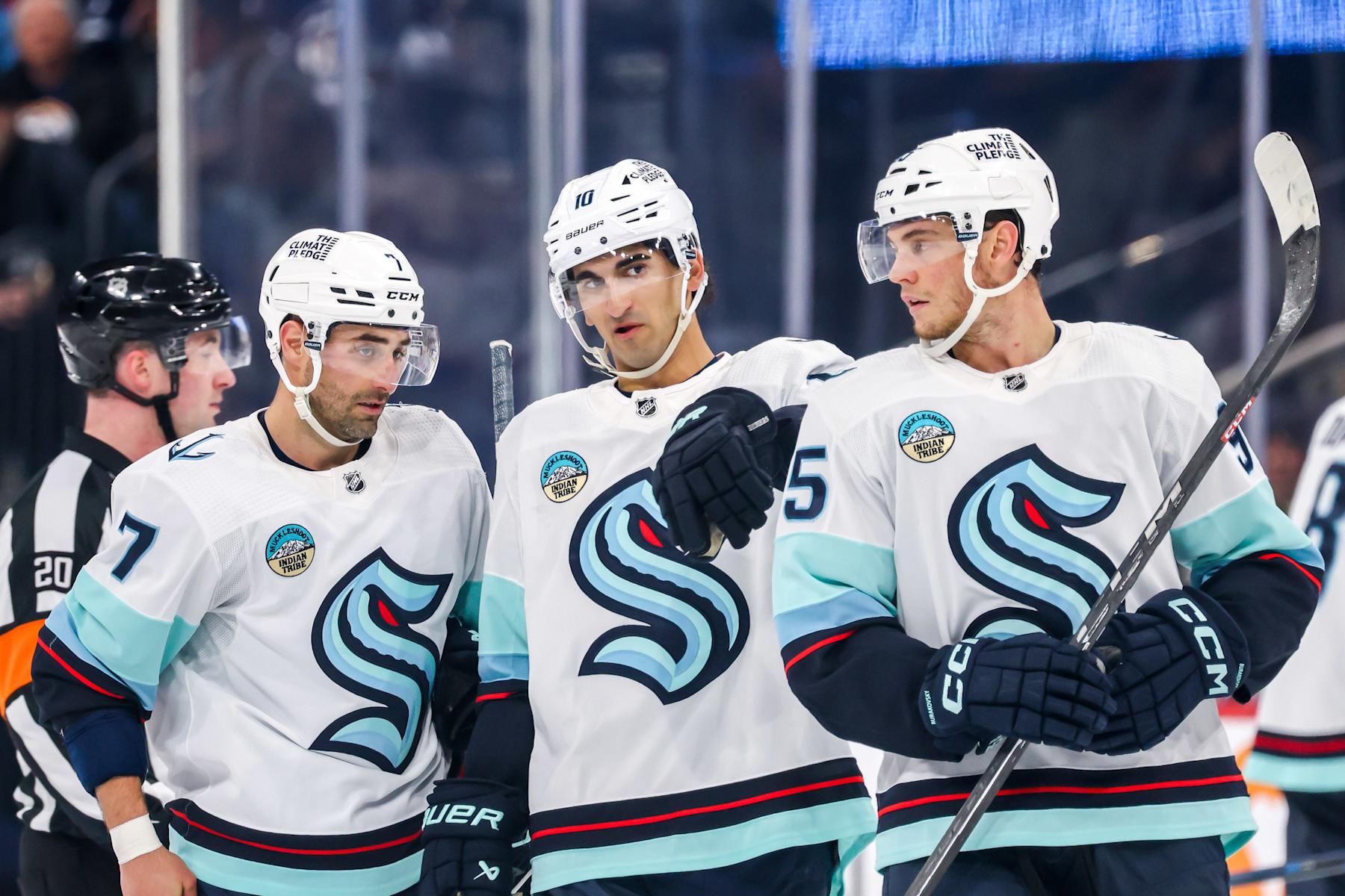 WINNIPEG, CANADA - APRIL 16: Jordan Eberle #7, Matty Beniers #10 and Andre Burakovsky #95 of the Seattle Kraken discuss strategy during a first period stoppage in play against the Winnipeg Jets at the Canada Life Centre on April 16, 2024 in Winnipeg, Manitoba, Canada. (Photo by Jonathan Kozub/NHLI via Getty Images)