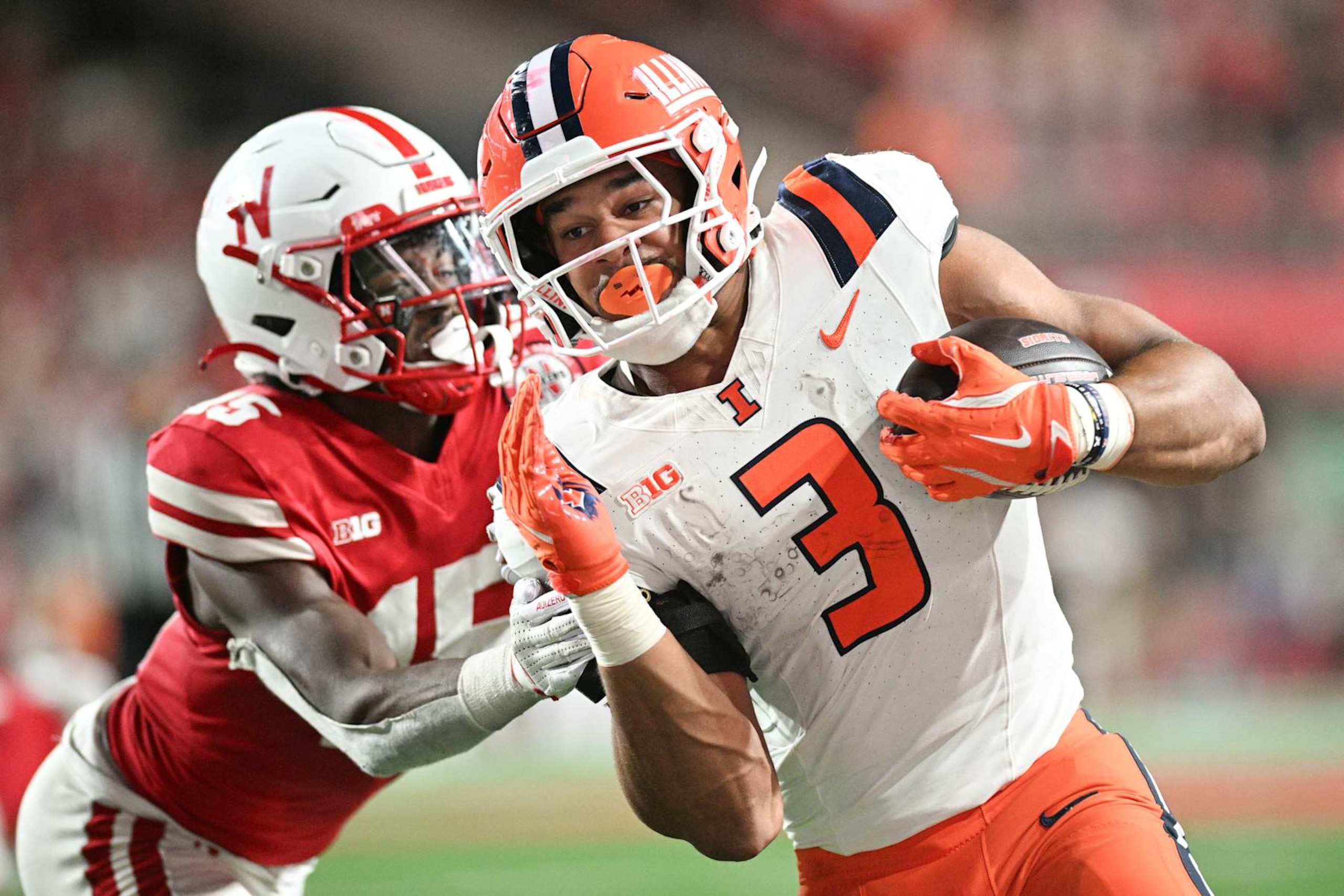 LINCOLN, NEBRASKA - SEPTEMBER 20: Kaden Feagin #3 of the Illinois Fighting Illini runs for a first down against Ceyair Wright #15 of the Nebraska Cornhuskers during overtime at Memorial Stadium on September 20, 2024 in Lincoln, Nebraska.  (Photo by Steven Branscombe/Getty Images)
