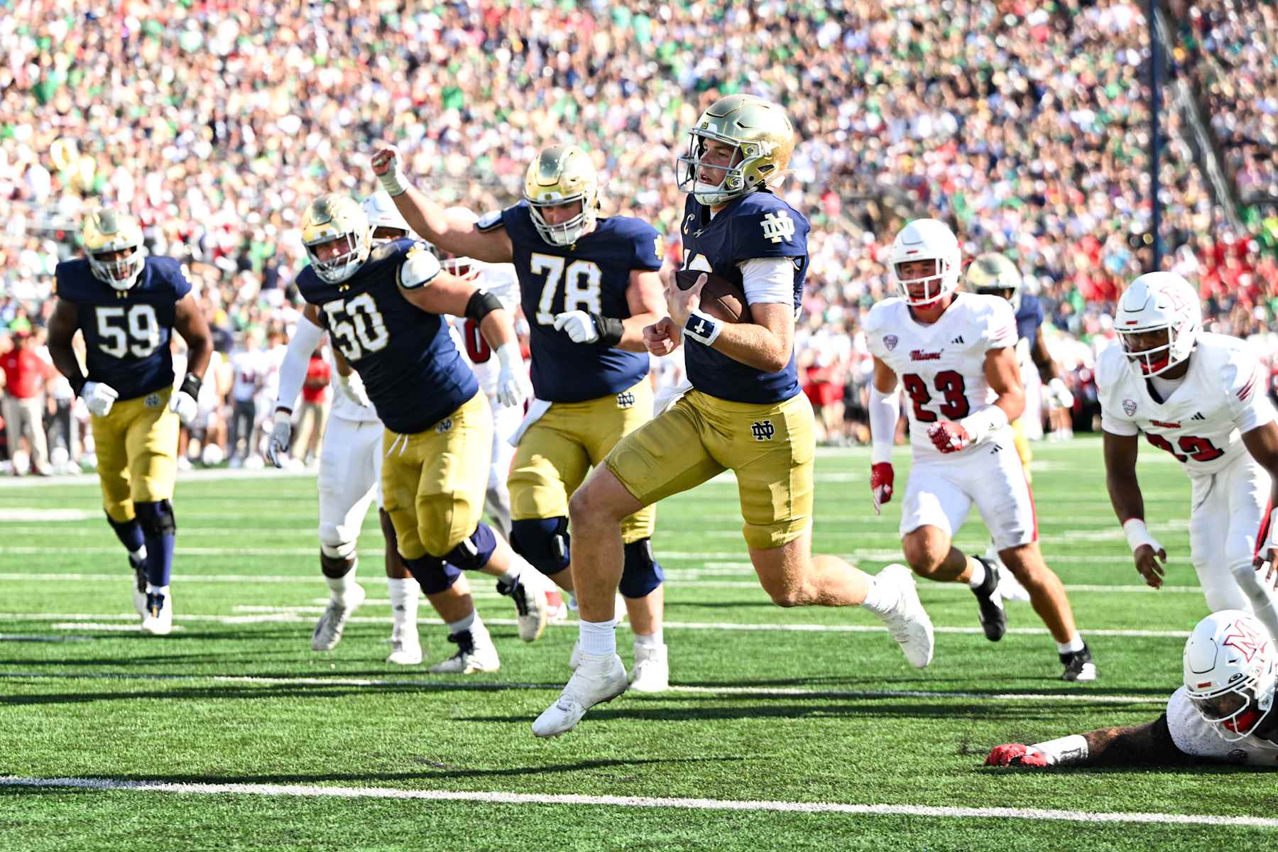 SOUTH BEND, IN - SEPTEMBER 21: Notre Dame Fighting Irish QB Riley Leonard (13) runs the ball in for a touchdown during a college football game between the Notre Dame Fighting Irish and Miami RedHawks on September 21, 2024 at Notre Dame Stadium in South Bend, IN (Photo by James Black/Icon Sportswire via Getty Images)