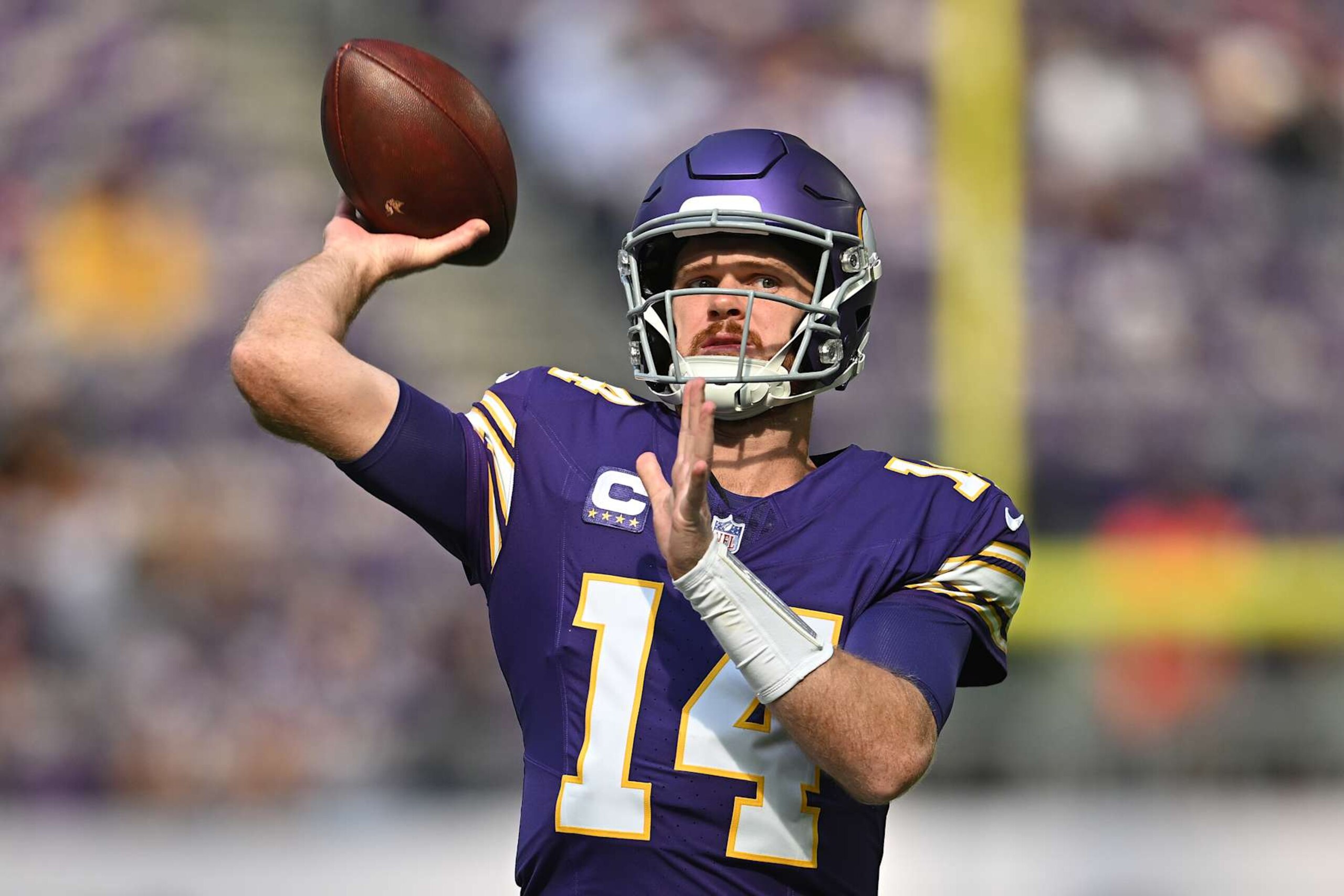 MINNEAPOLIS, MINNESOTA - SEPTEMBER 22: Quarterback Sam Darnold #14 of the Minnesota Vikings warms up before the game against the Houston Texans at U.S. Bank Stadium on September 22, 2024 in Minneapolis, Minnesota. (Photo by Stephen Maturen/Getty Images)