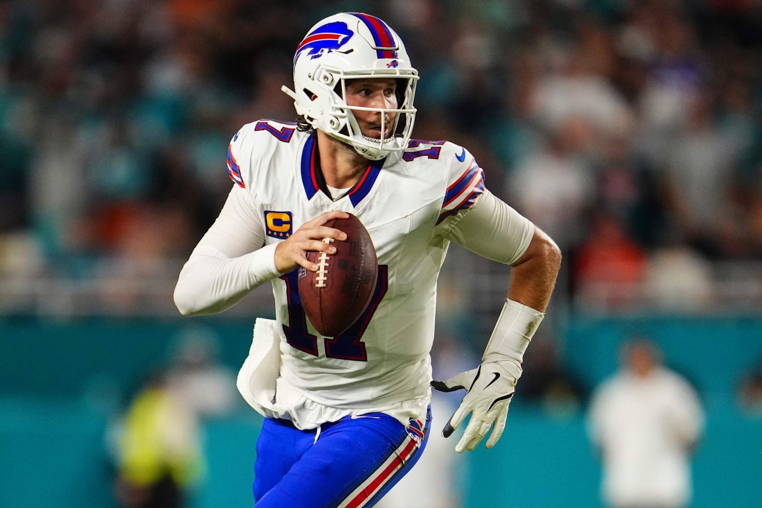 MIAMI GARDENS, FL - SEPTEMBER 12: Josh Allen #17 of the Buffalo Bills scrambles out of the pocket during an NFL football game against the Miami Dolphins at Hard Rock Stadium on September 12, 2024 in Miami Gardens, Florida. (Photo by Cooper Neill/Getty Images)