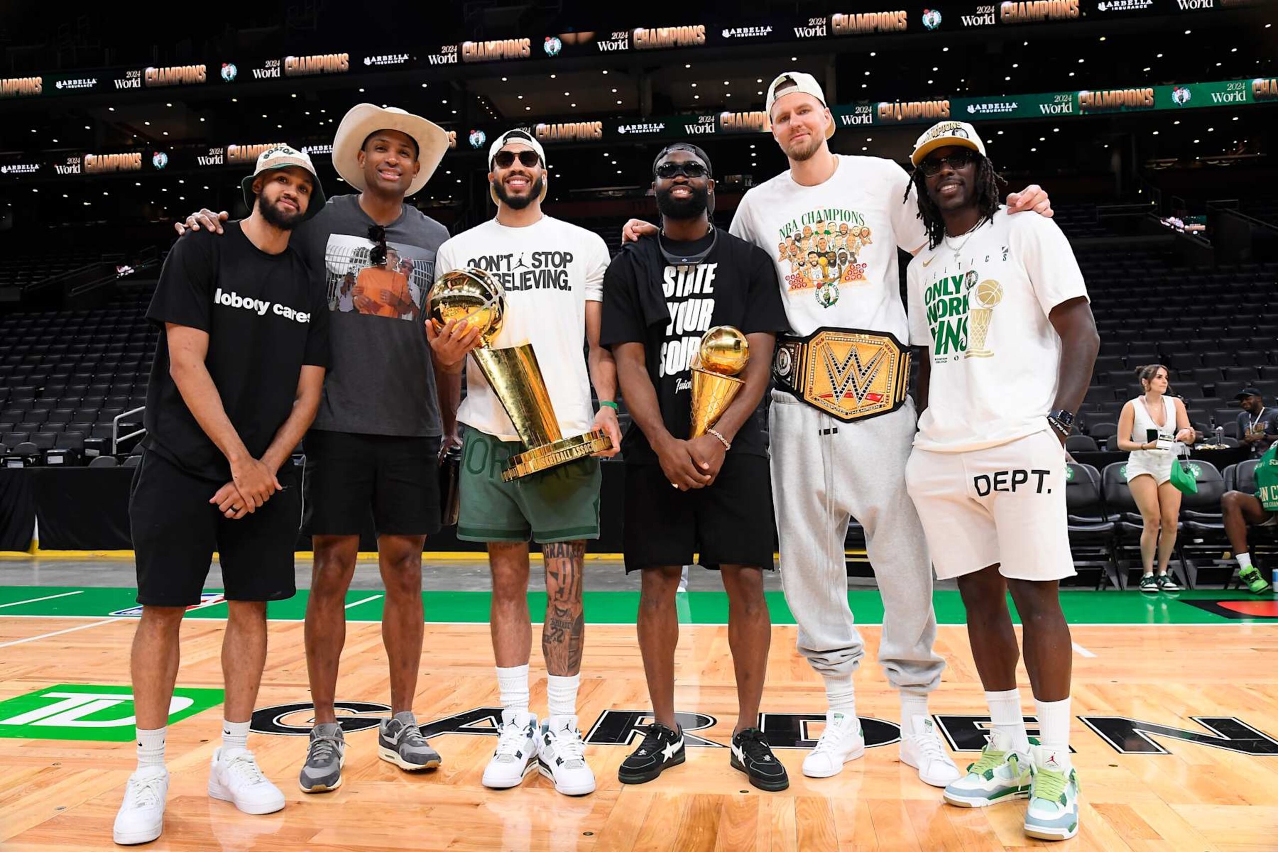 BOSTON, MA - JUNE 21: Derrick White #9, Al Horford #42, Jayson Tatum #0, Jaylen Brown #7, Kristaps Porzingis #8, and Jrue Holiday #4 of the Boston Celtics pose for a photo with the Larry O'Brien Trophy and the Bill Russell Finals MVP Trophy before the 2024 Boston Celtics championship parade on June 21, 2024 in Boston, Massachusetts. NOTE TO USER: User expressly acknowledges and agrees that, by downloading and or using this photograph, User is consenting to the terms and conditions of the Getty Images License Agreement. Mandatory Copyright Notice: Copyright 2024 NBAE (Photo by Brian Babineau/NBAE via Getty Images)